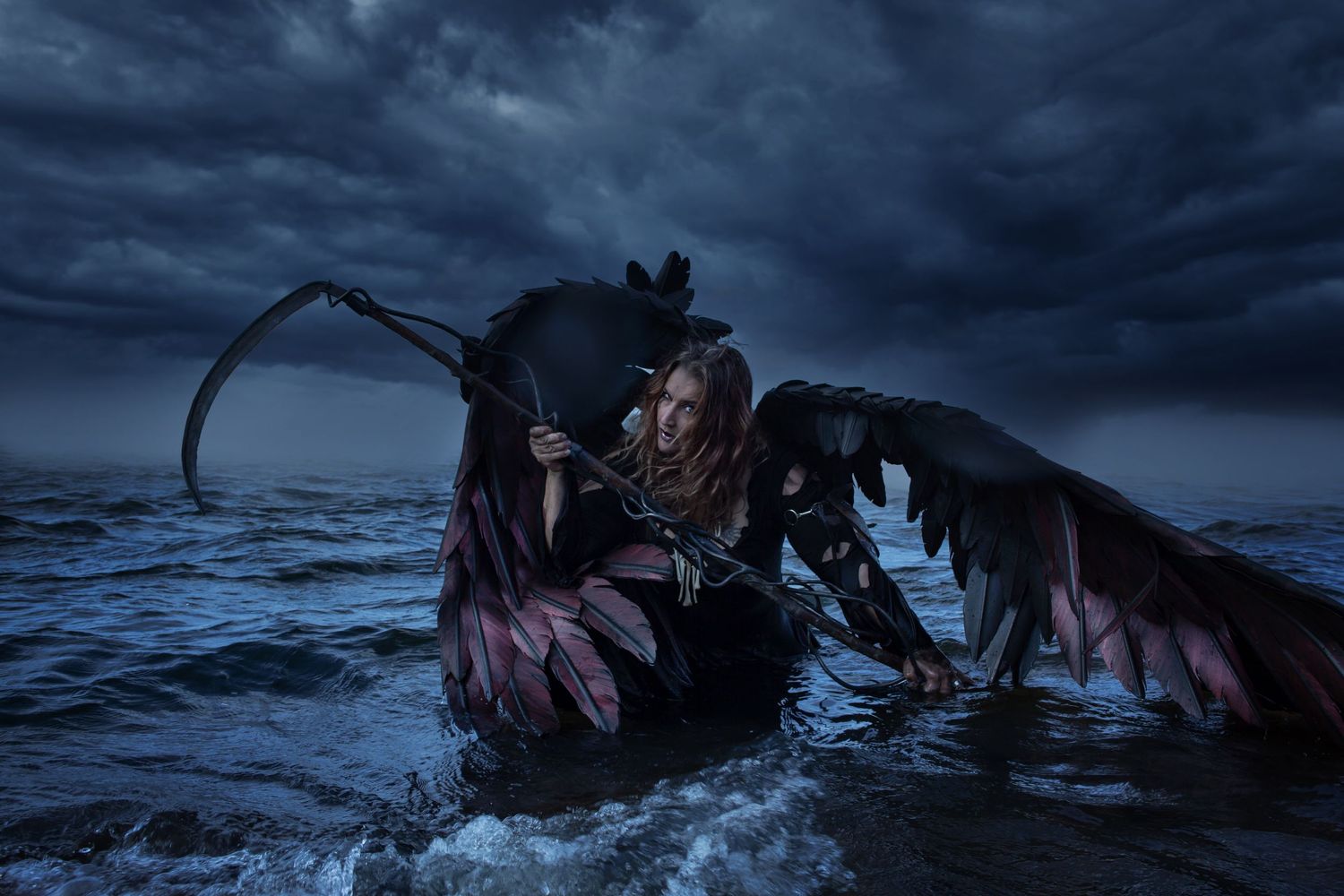 A dark figure with wings and a scythe emerges from stormy waters at night against a moody sky.