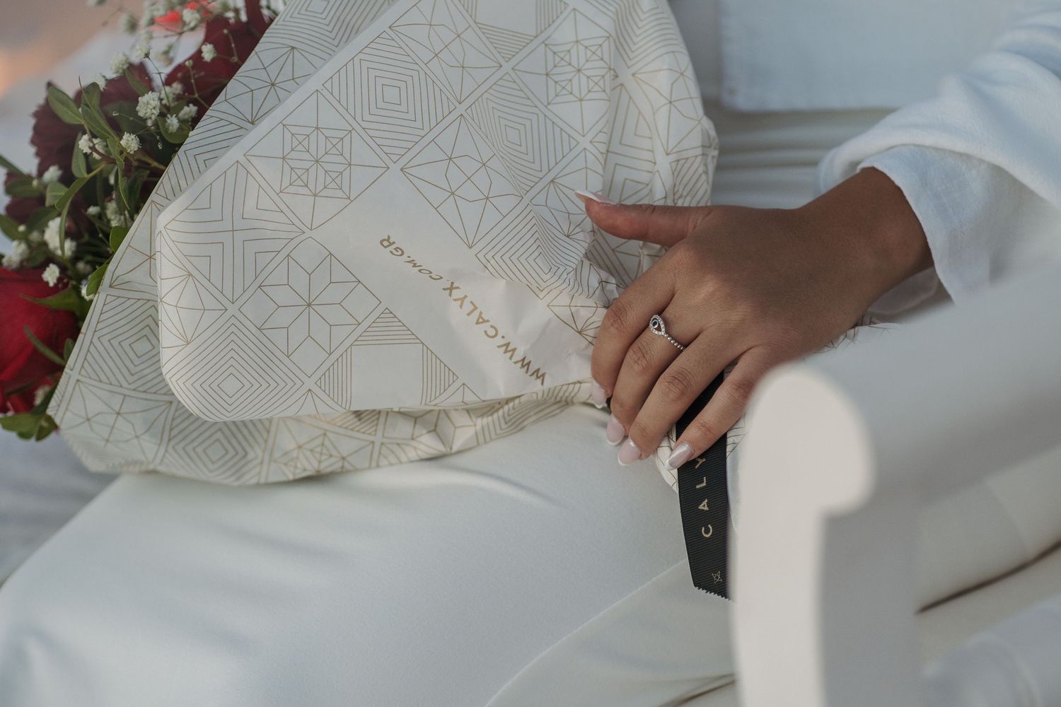 Close-up shots of a romantic proposal with white floral decorations.