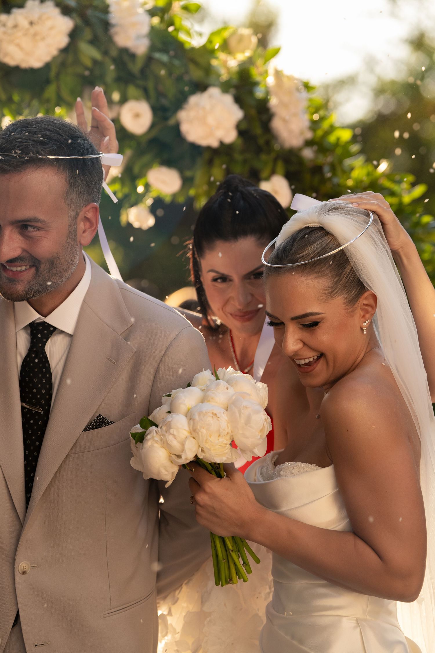 A joyful wedding moment captured in a series of candid shots showing laughter and celebration in golden sunlight.
