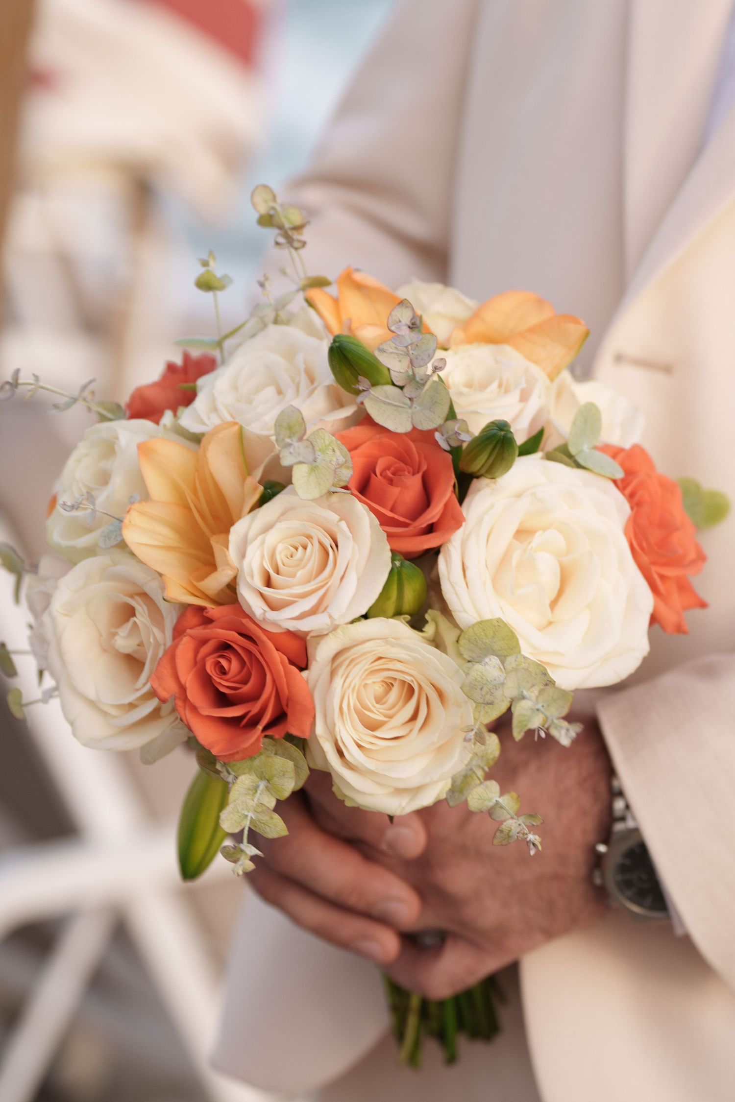 A series of elegant wedding bouquets featuring cream and coral roses with delicate greenery held by hands in white sleeves.