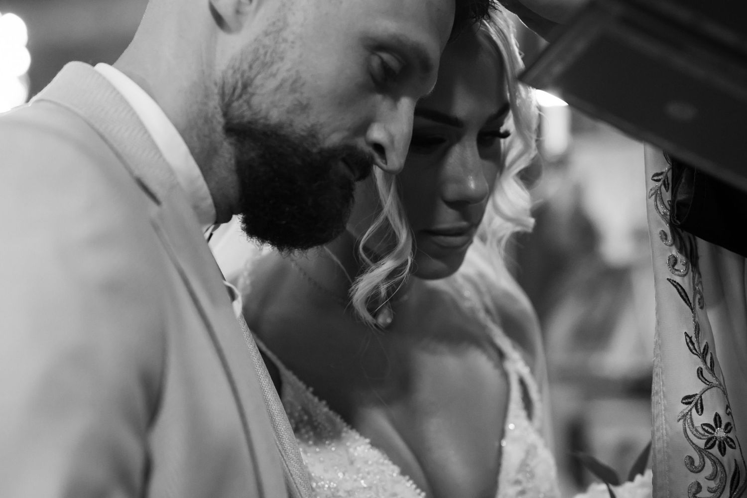 Close-up black and white shot of tender wedding moment.