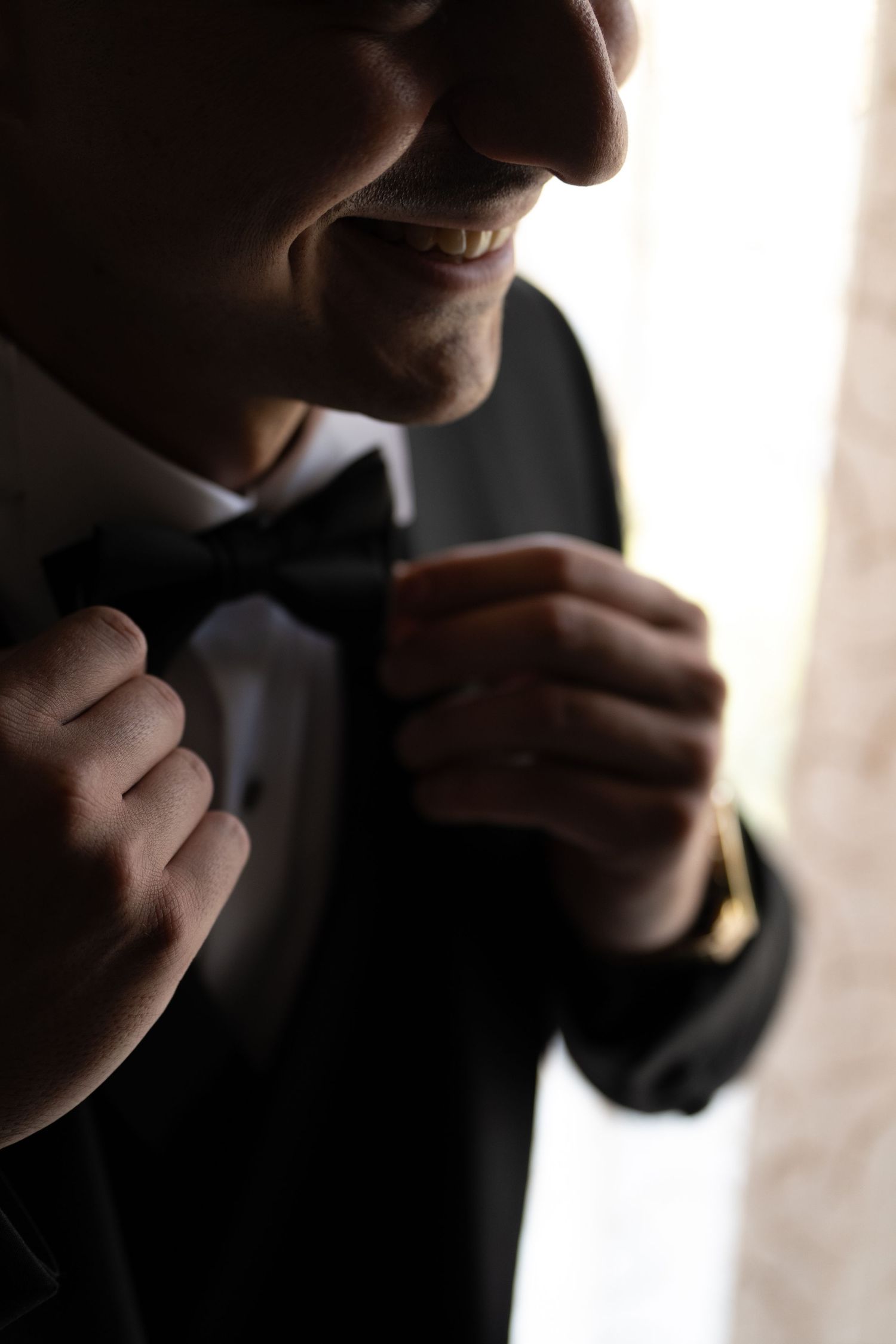 Close-up silhouette shots of someone adjusting formal attire.