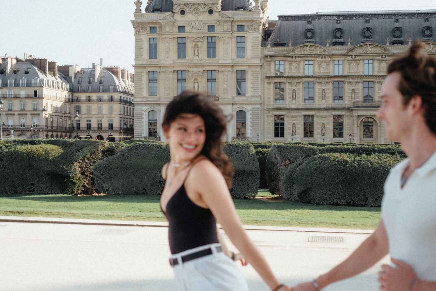 Tourist takes photos at the Luxembourg Palace gardens on a sunny day in Paris, France.
