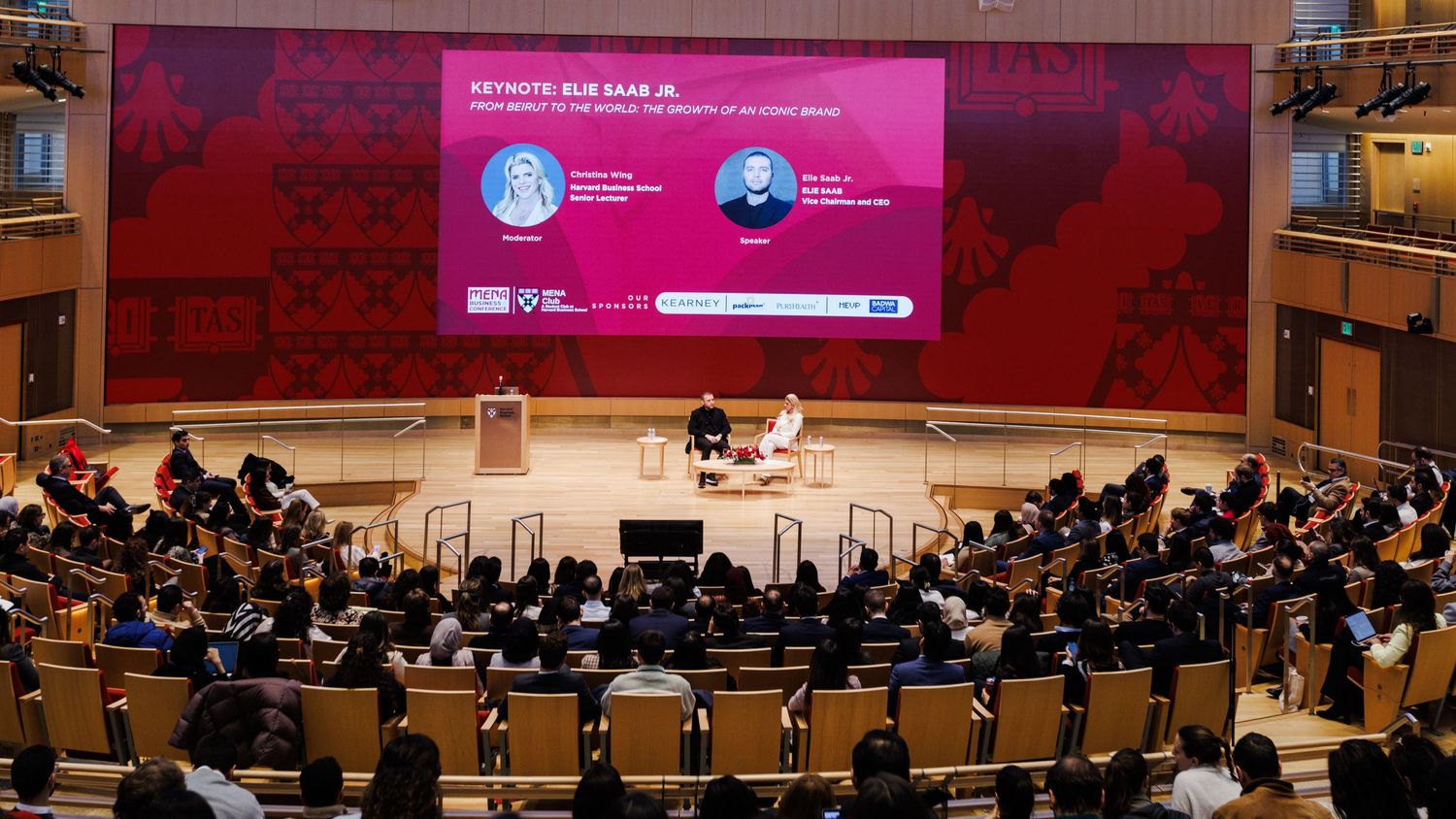 Keynote speaker Elie Masr Jr. addresses a large audience in a modern auditorium.