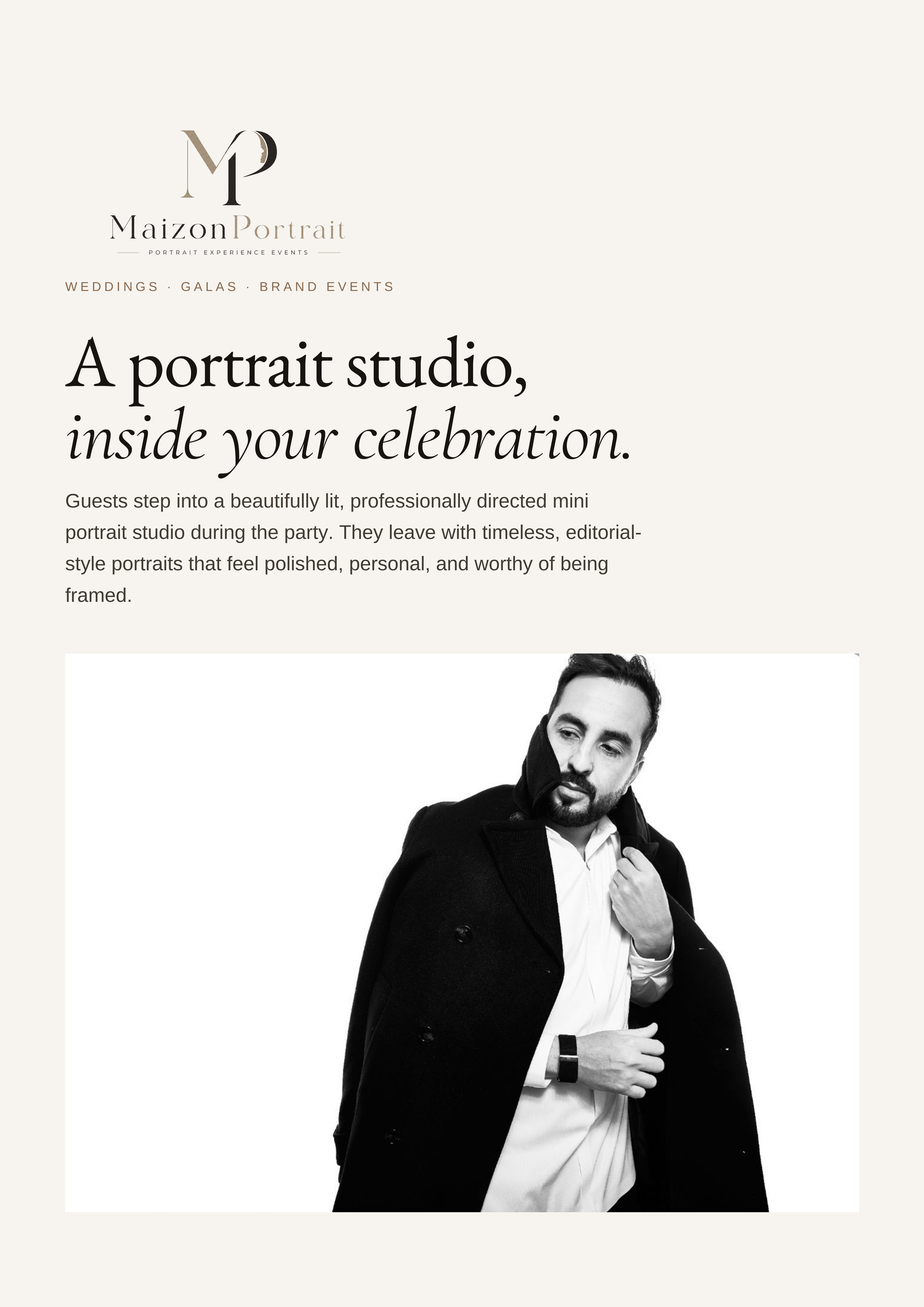A man in a black coat poses confidently in a professional portrait studio setting for MaizonPortrait.