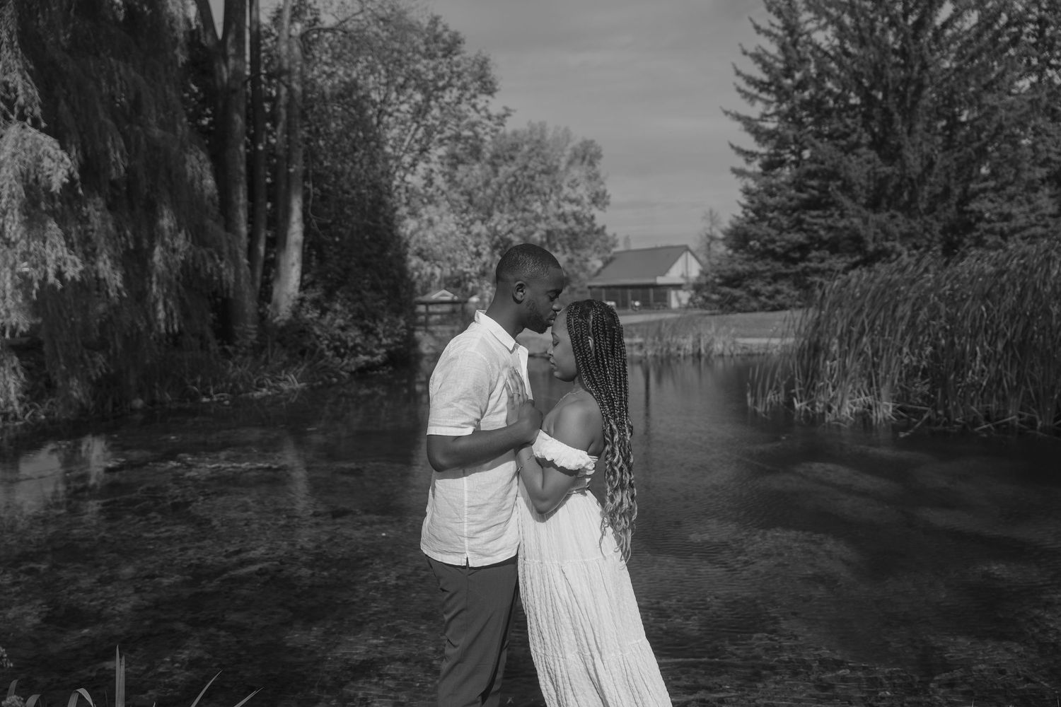 A black and white photo series showing a couple walking together on a tree-lined path through various romantic moments.