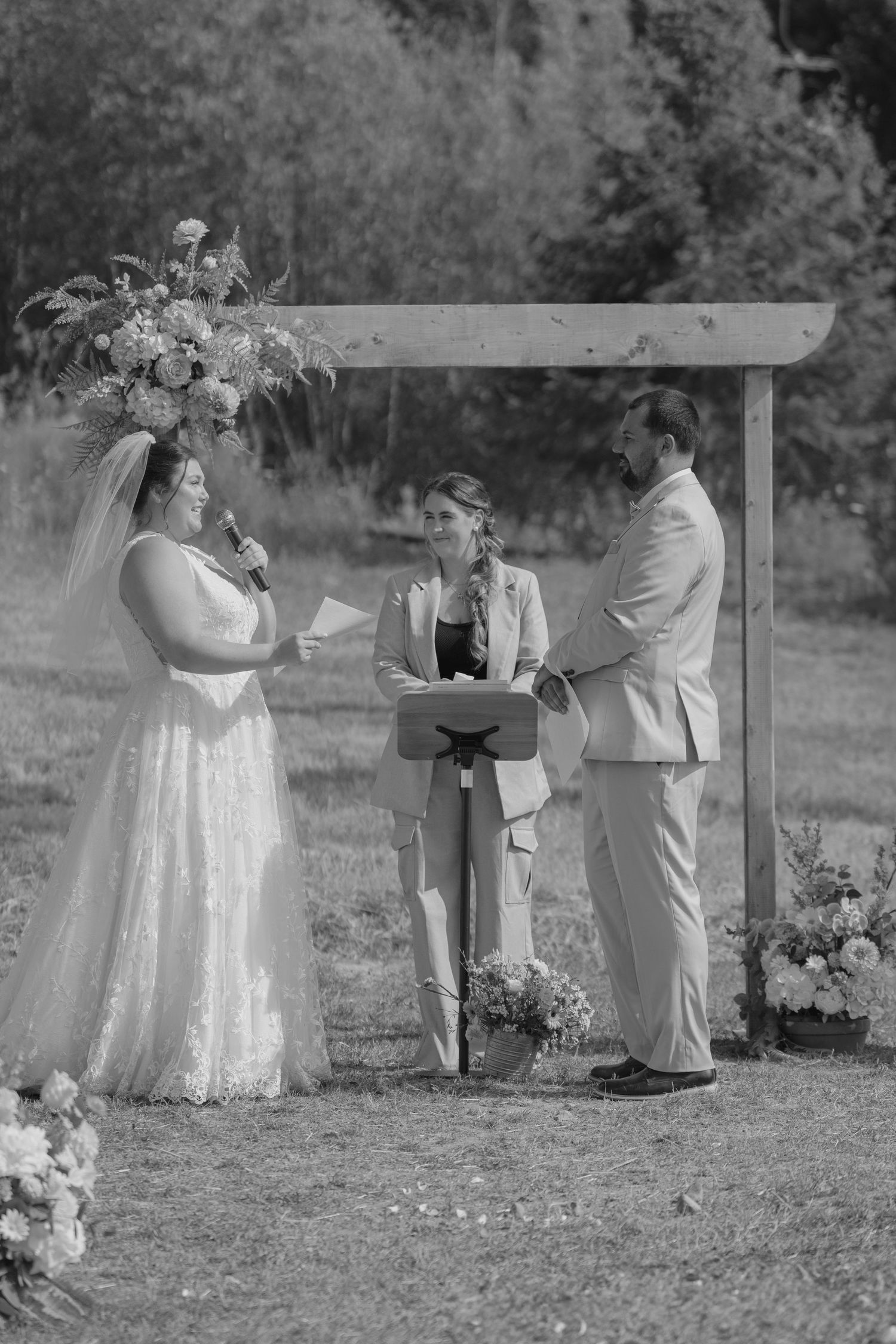 Black and white wedding ceremony photos showing intimate outdoor moments between couples during a garden celebration.
