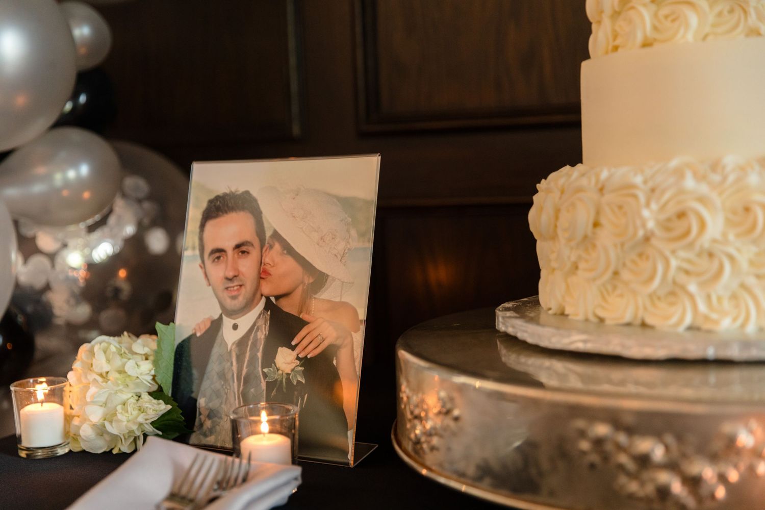 Wedding cake and decor details on display at reception.