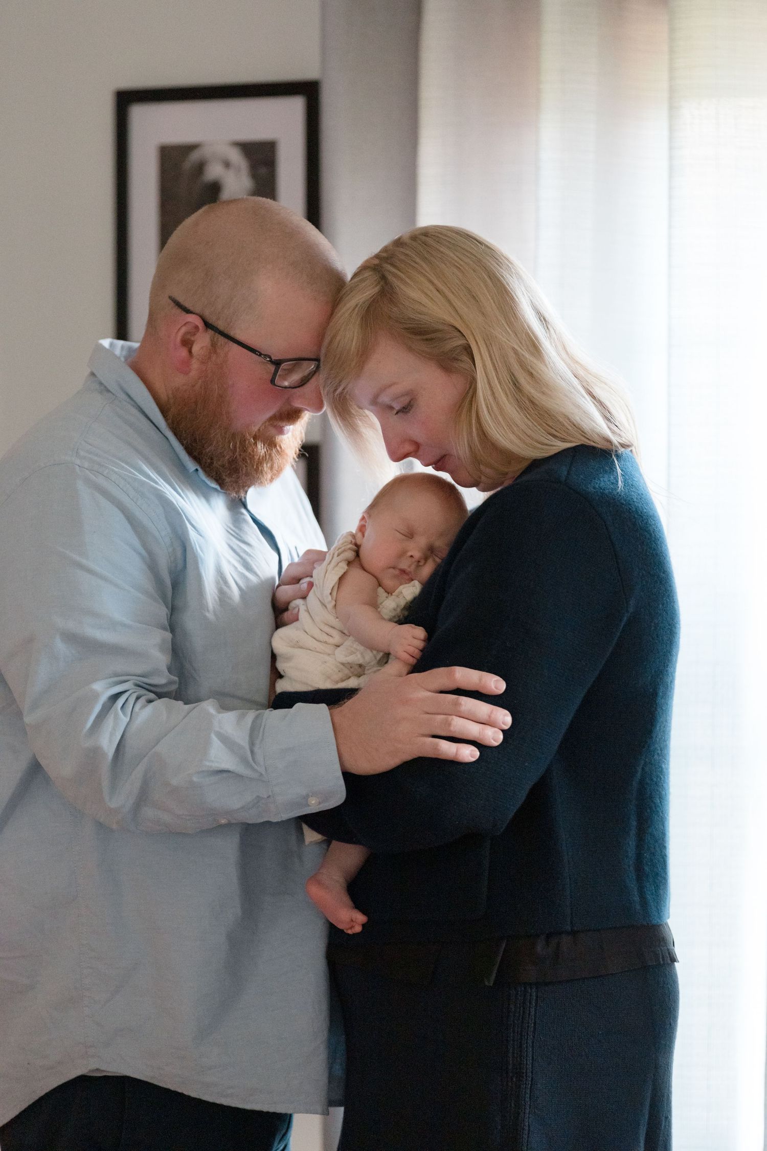 Series of tender indoor family moments with baby against bright window backdrop.