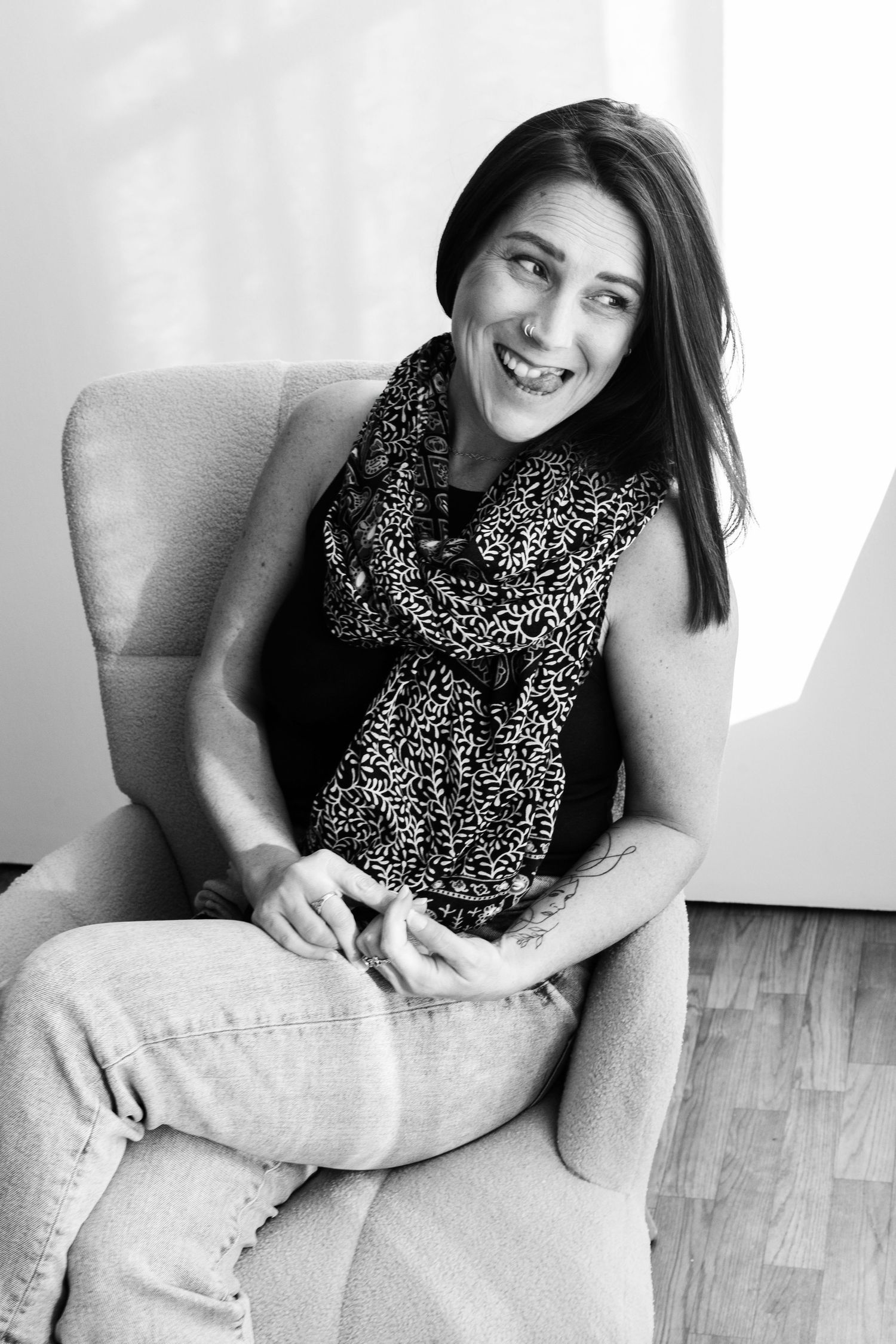 A series of black and white portraits showing a person sitting casually in an armchair.