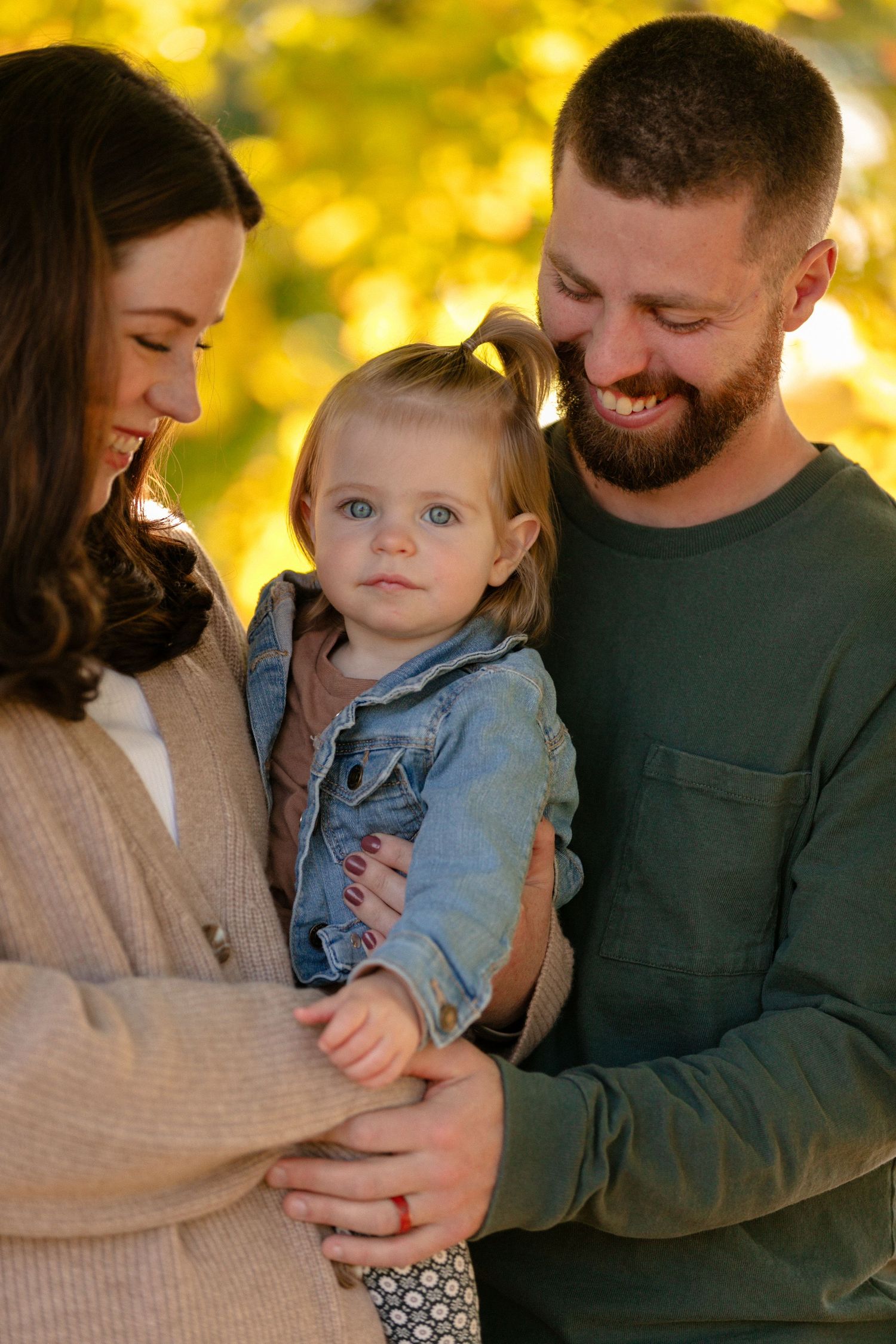 A family shares an intimate moment together in warm golden sunlight.