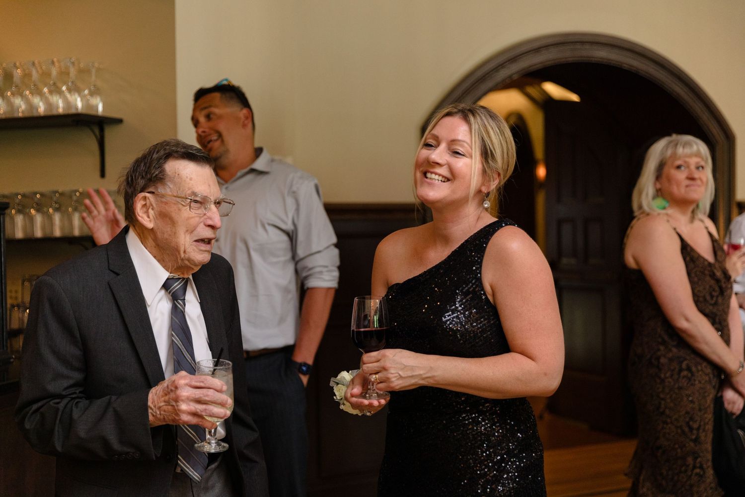 Candid moments of guests enjoying themselves at an evening celebration.
