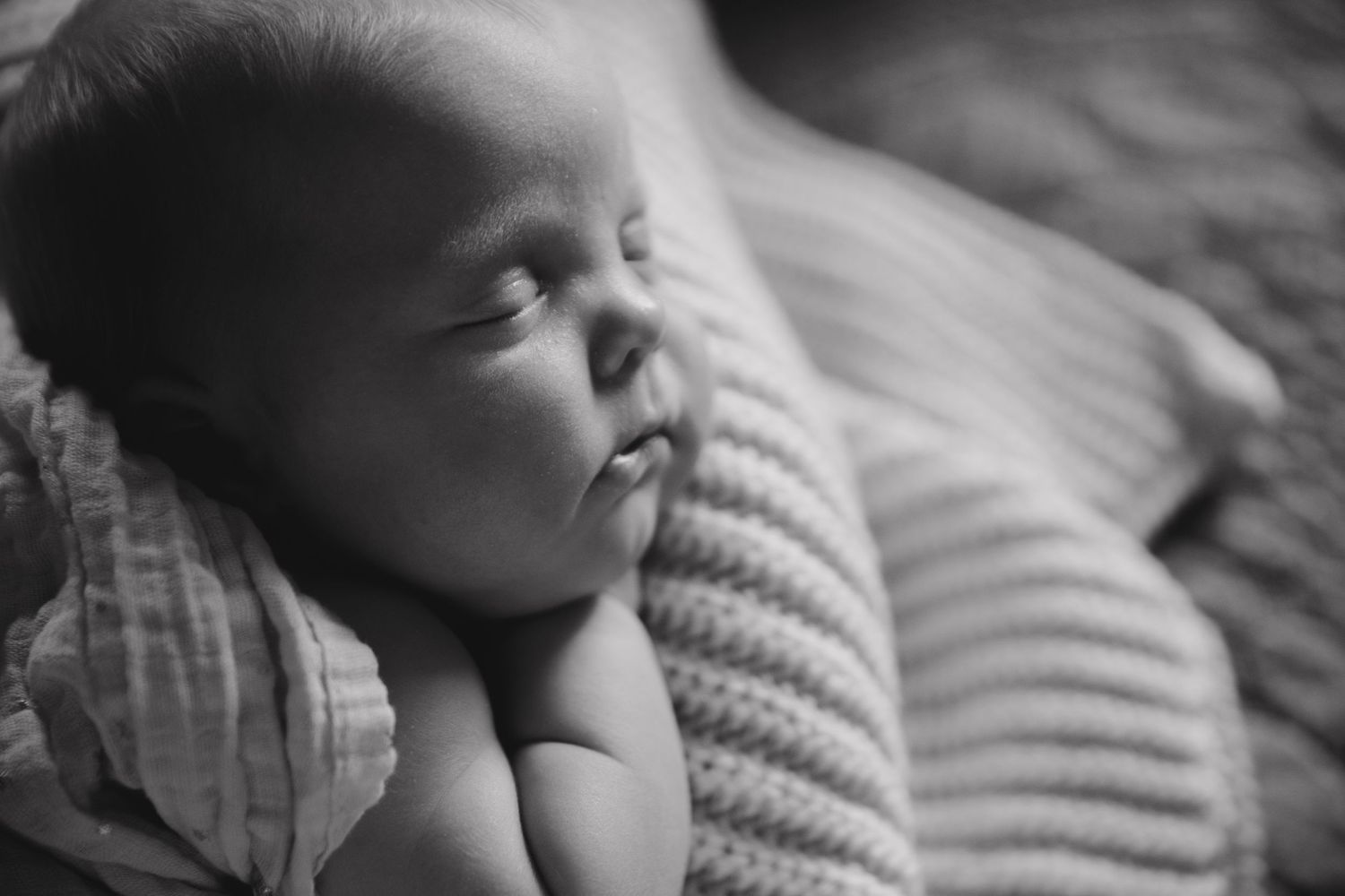 Close-up black and white images of sleeping infant details.