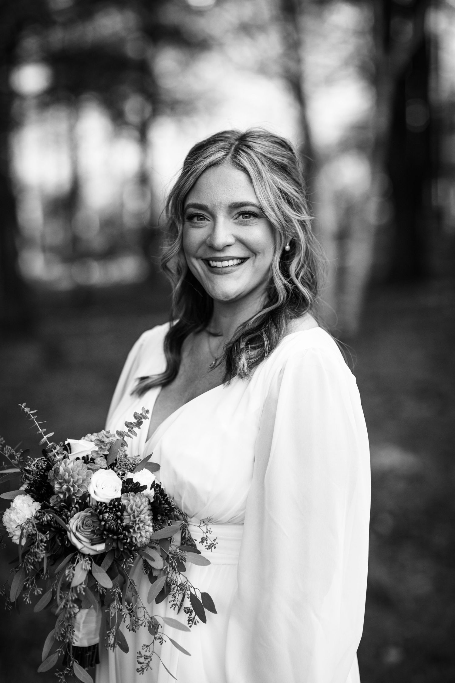 Black and white portrait series showing a bride in white holding a floral bouquet against a natural outdoor background.