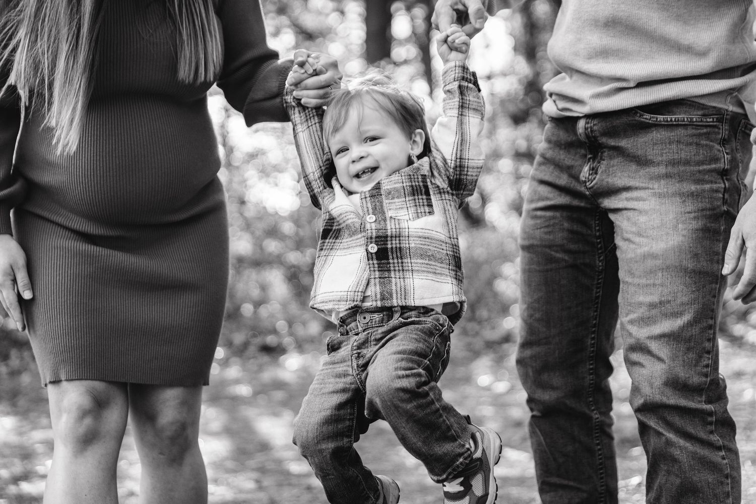 Black and white detail shot of casual clothing and shoes in outdoor setting.