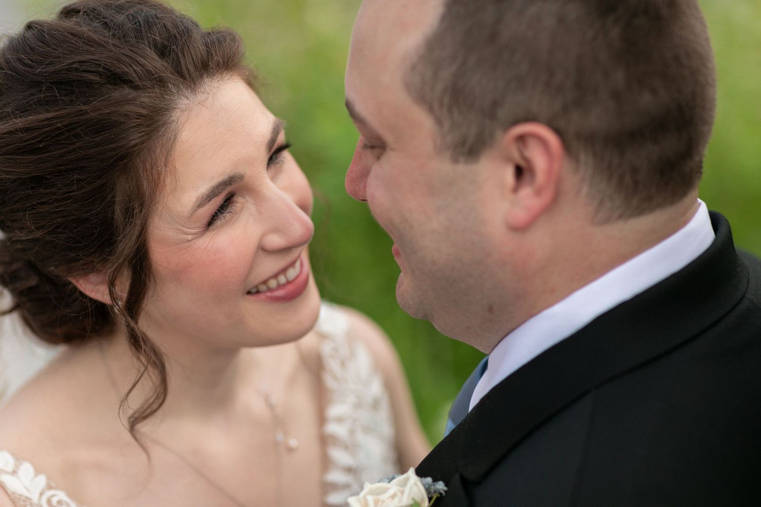 An intimate close-up of a wedding couple sharing a joyful moment together.