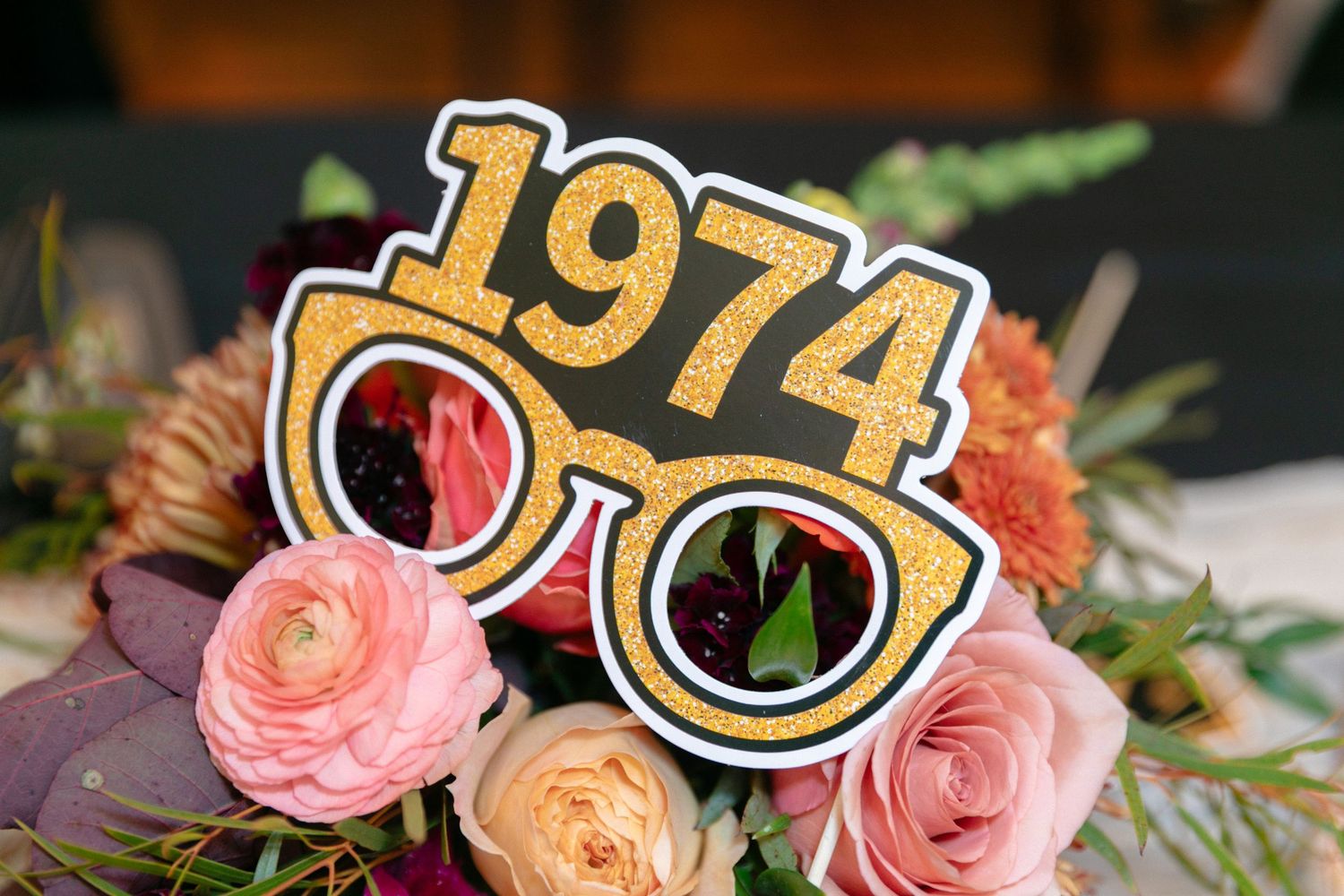 Decorative display featuring vintage-style numbers and pink roses.