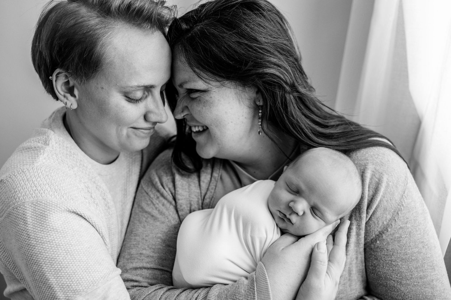 Intimate black and white portrait of a couple sharing tender moments together.