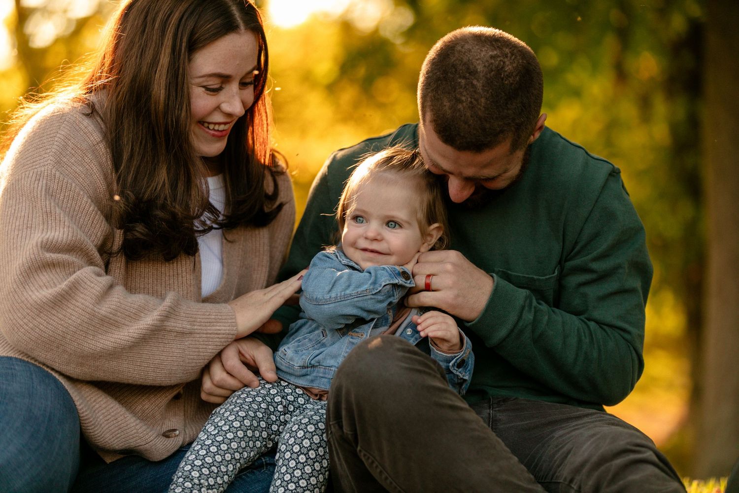 Candid family moments captured during sunset photo session in natural setting.
