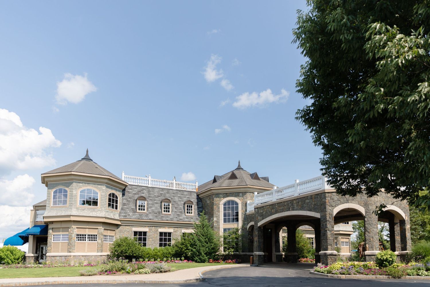 Panoramic exterior view of an elegant venue building with columns and arches.