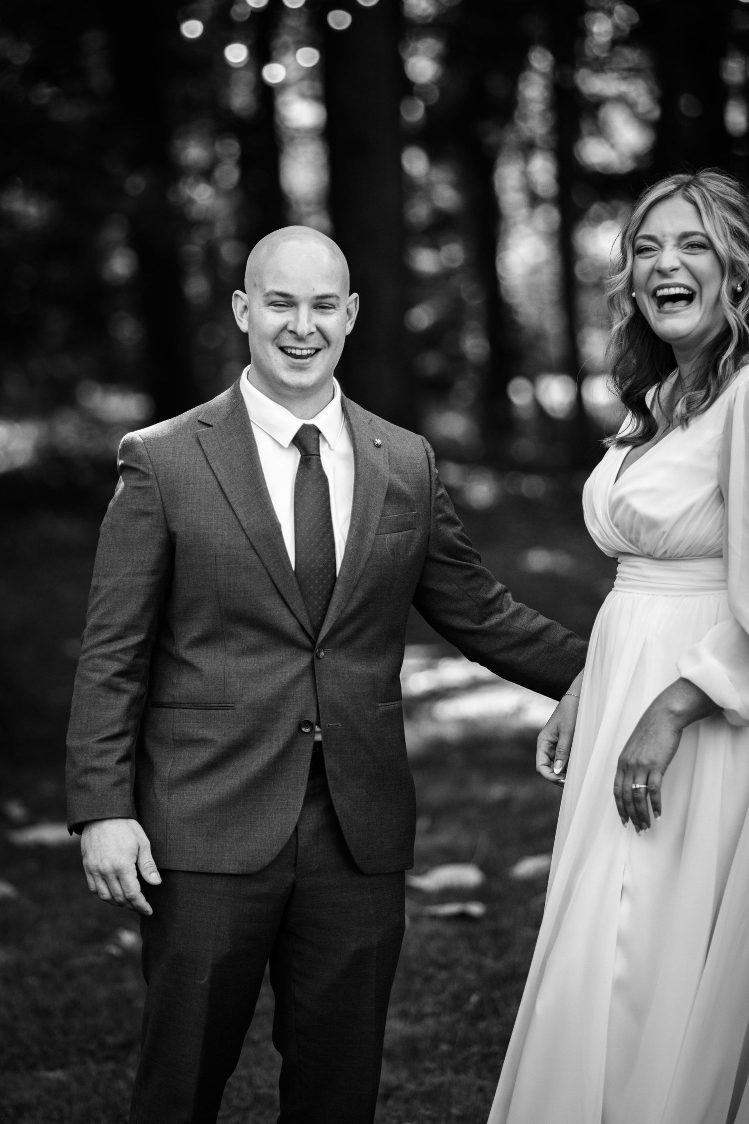 Black and white candid wedding photos showing joyful laughter.