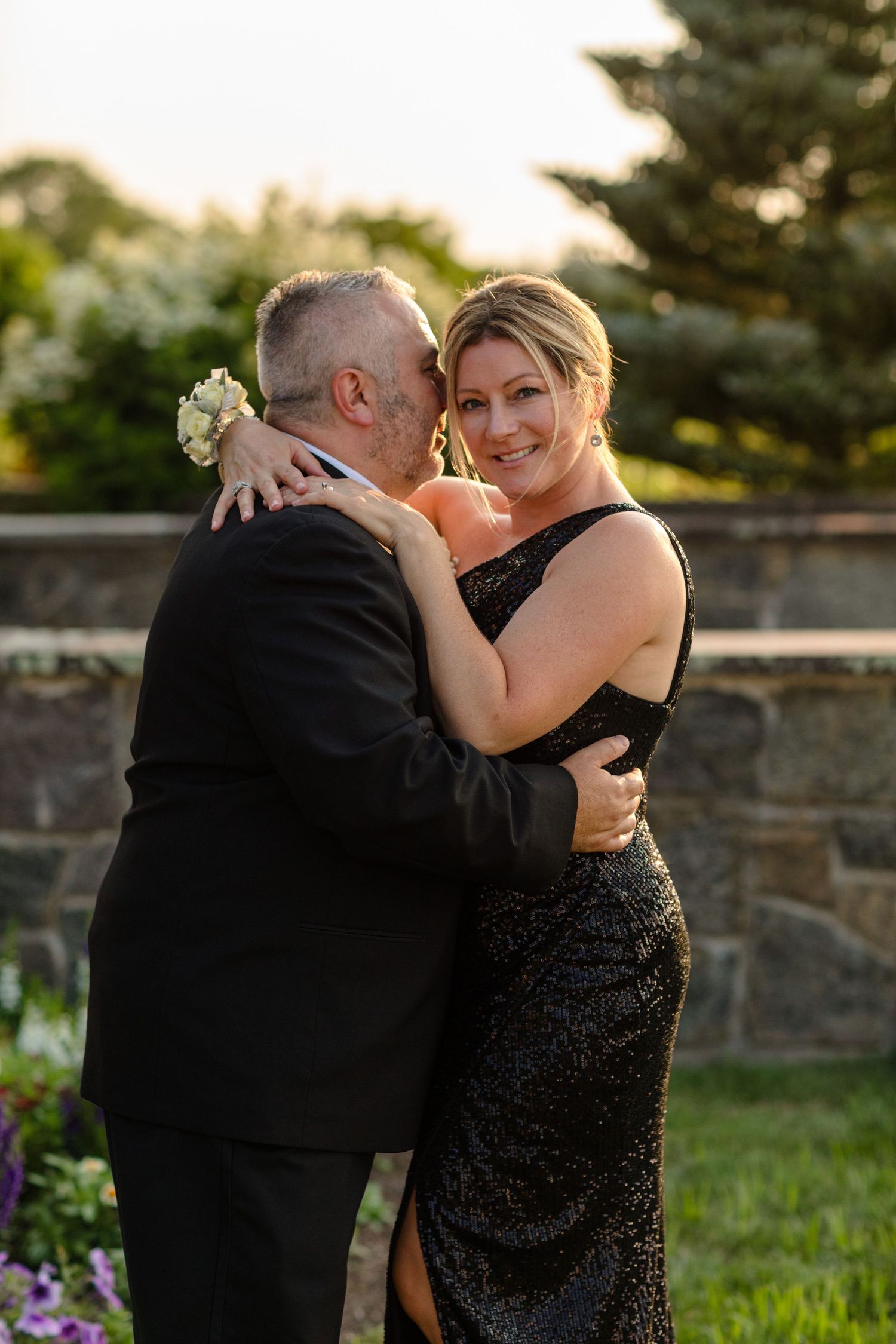 A couple sharing an intimate moment outdoors during golden hour.