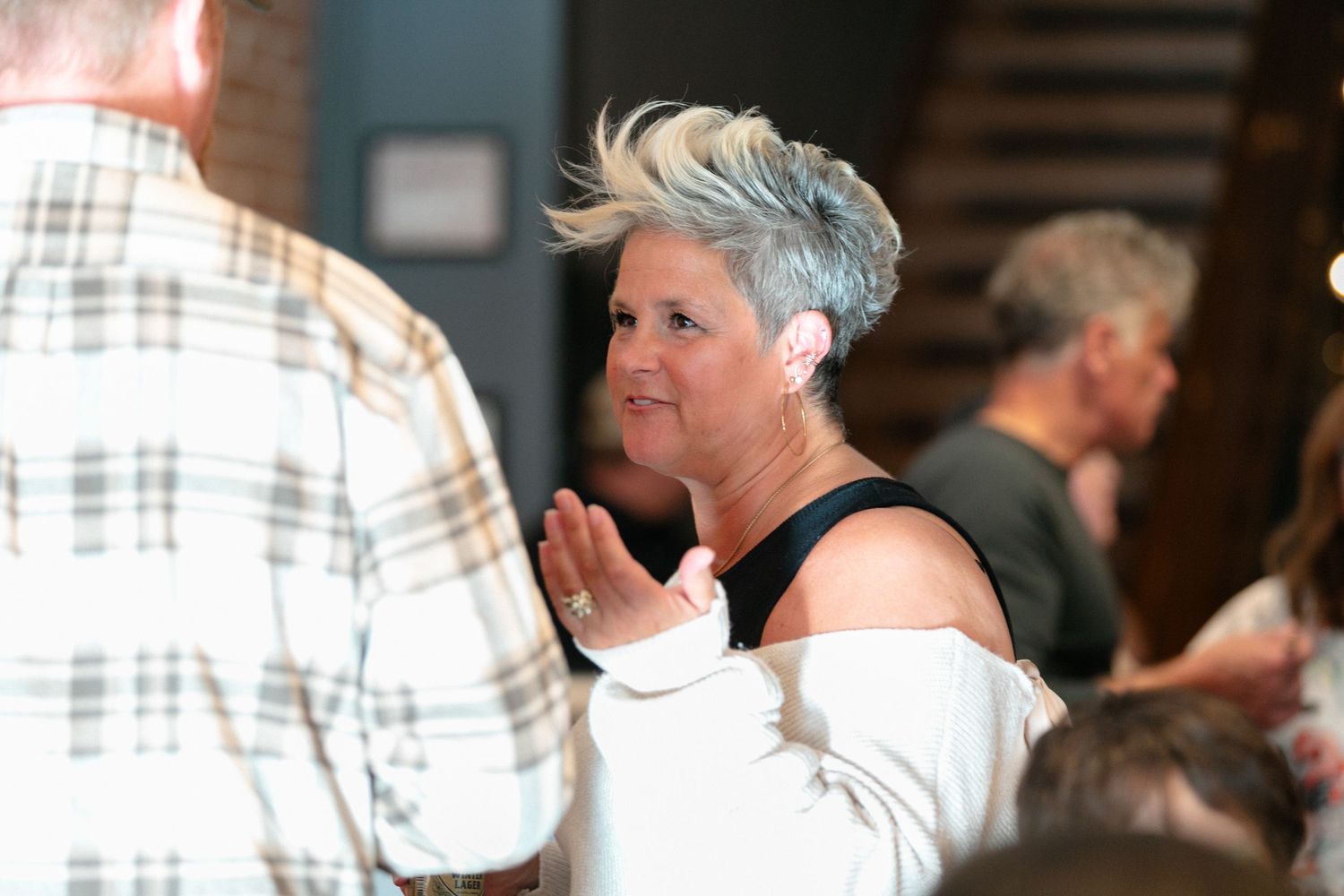 People mingling at an indoor social event.