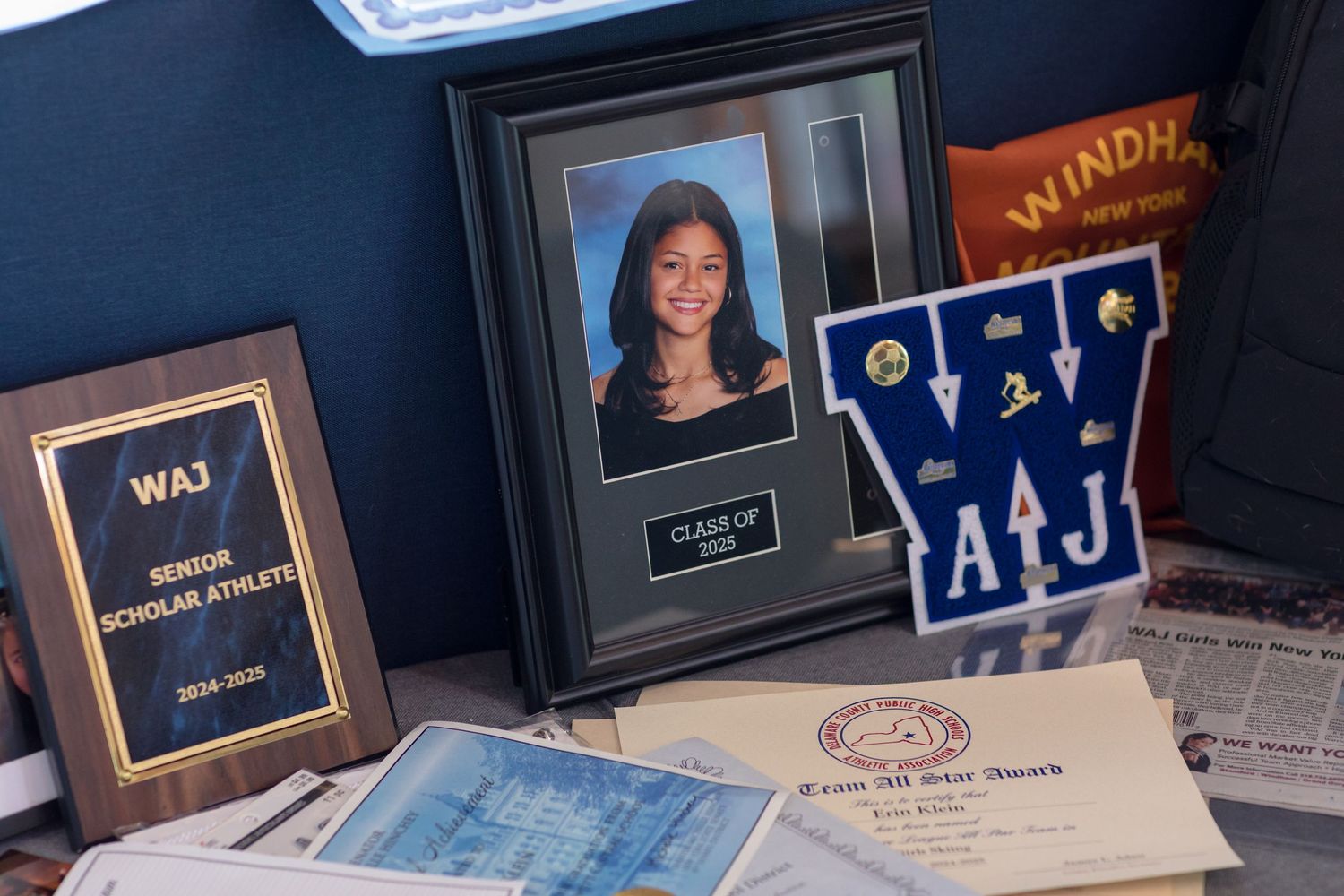 A collection of graduation ceremony name cards and decorative frames displayed on a table.