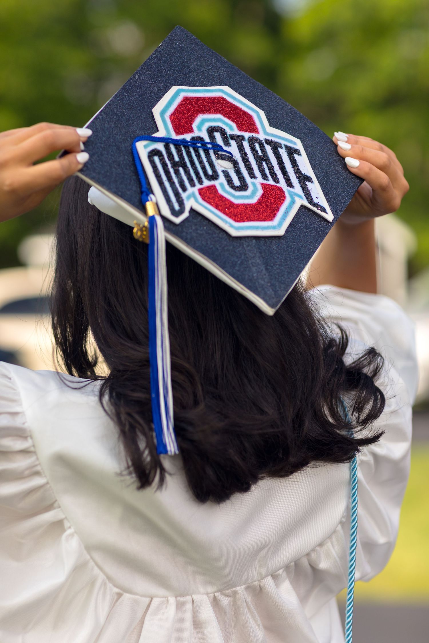 A decorated graduation cap featuring the Ohio State University logo in red and blue.