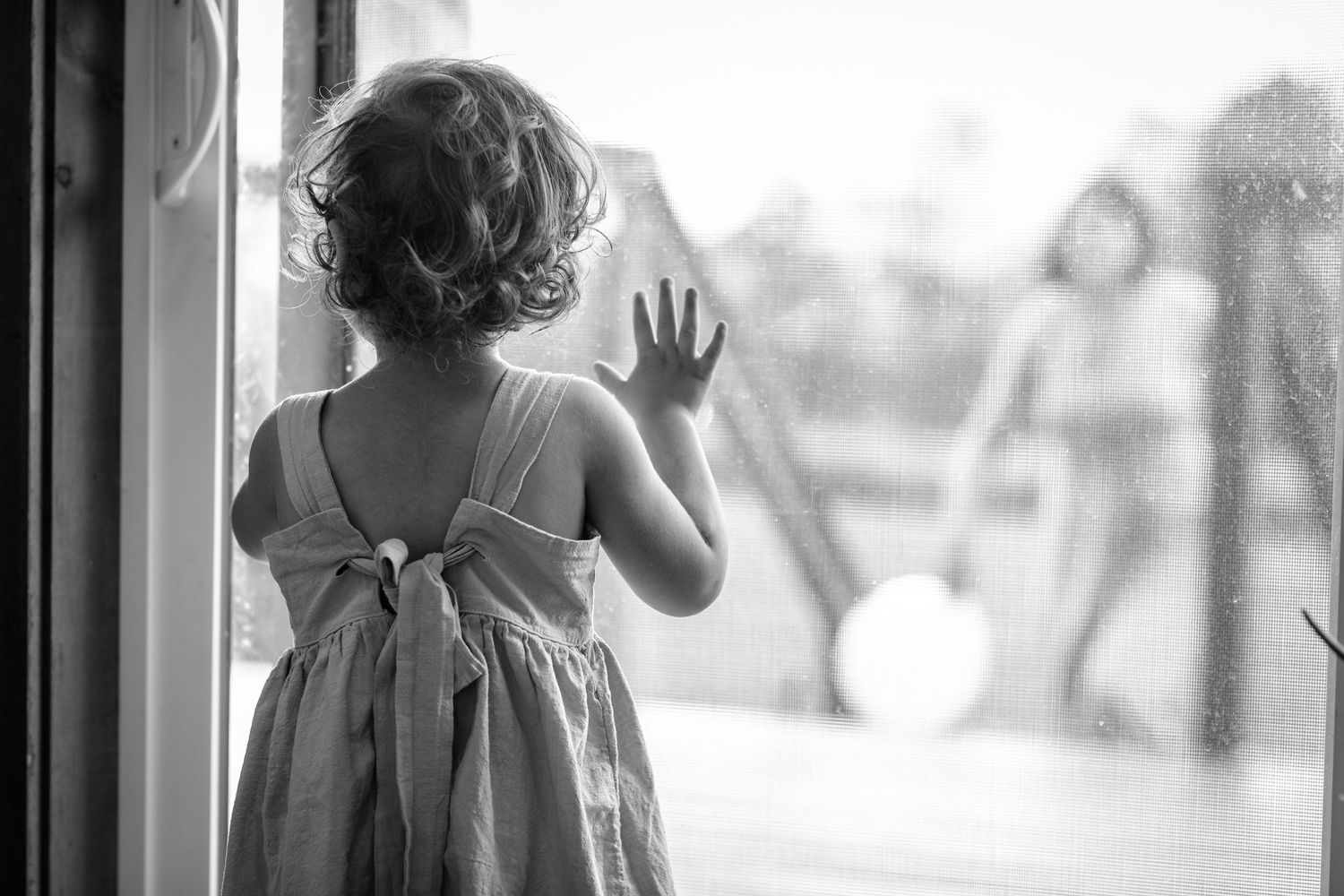 Black and white candid shots through windows showing movement and silhouettes.