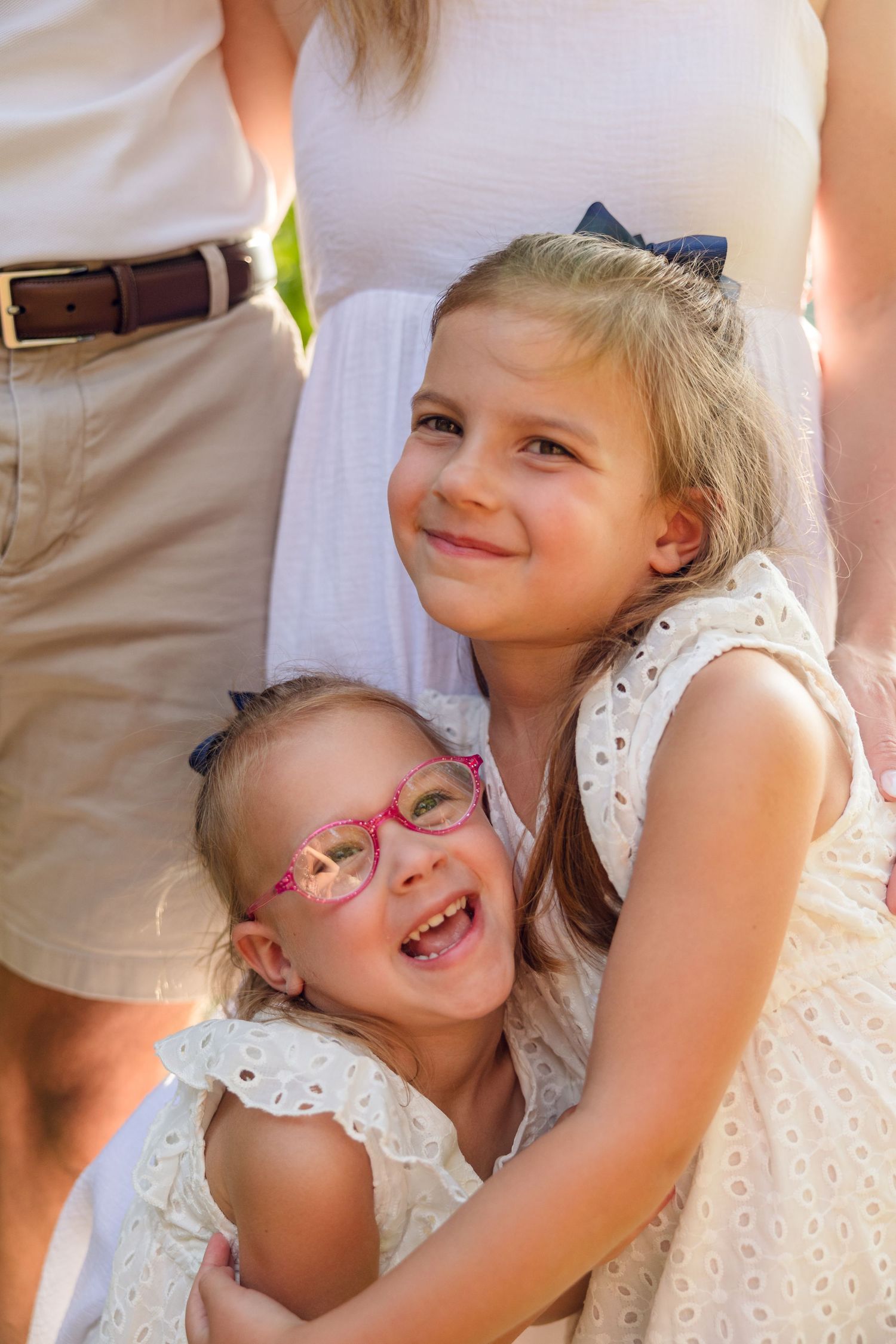 Series of playful expressions and laughter captured in close-up outdoor portraits.