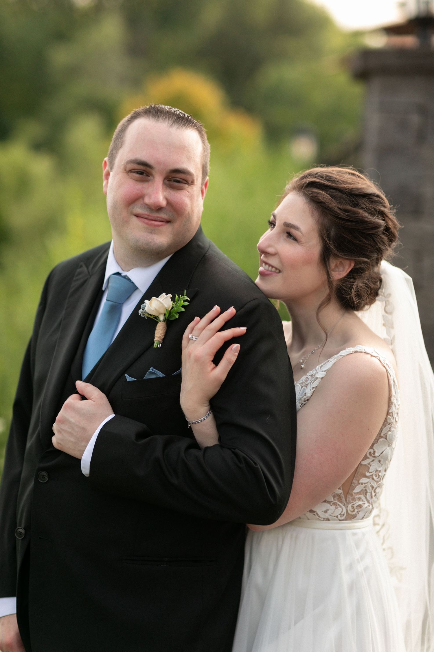 A romantic outdoor wedding portrait with the couple sharing a tender moment.
