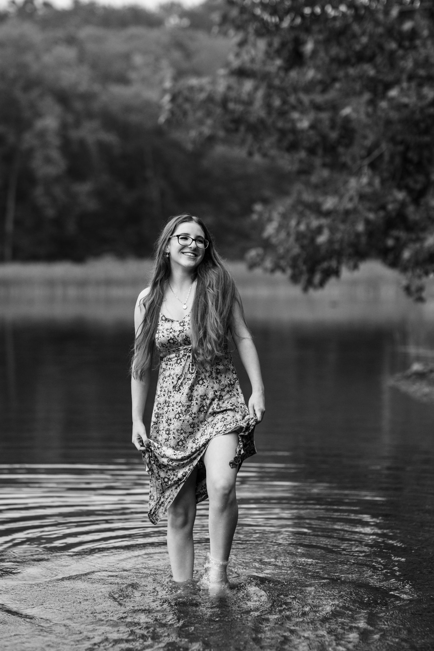 A black and white portrait captured while wading in lake water.