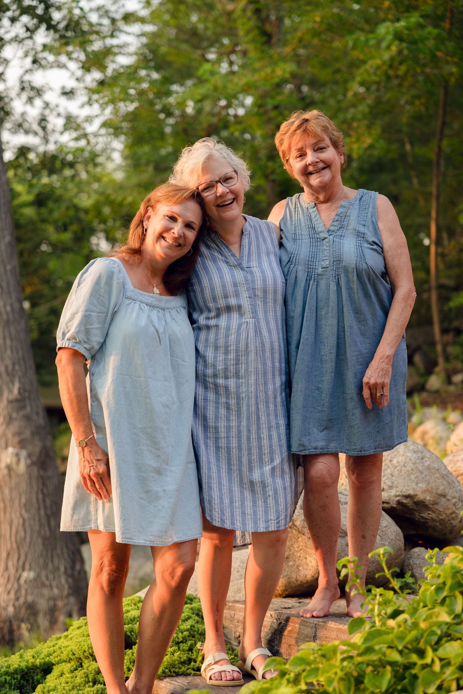 A group wearing coordinated blue and white outfits posing together outdoors.