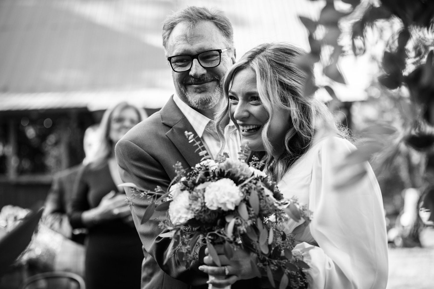 Black and white wedding photo series capturing tender moments between newlyweds.