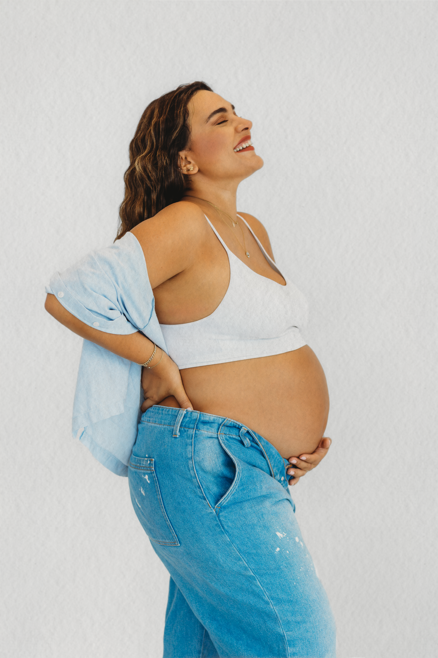 Pregnant mother in white top and jeans during a maternity session in Dbayeh, Lebanon