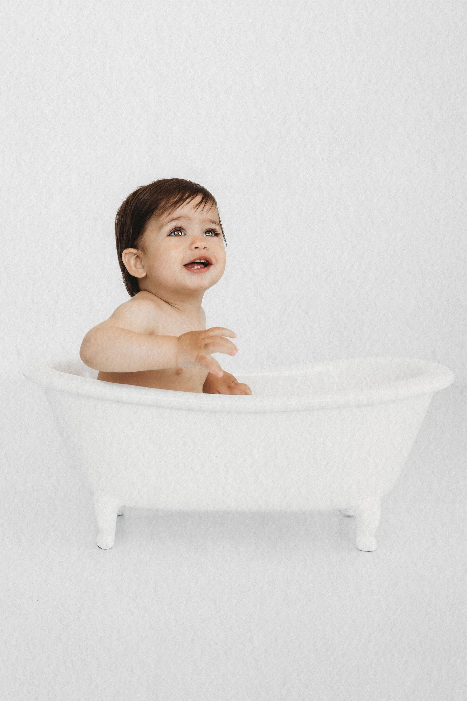 Baby exploring a cake during a first birthday cake smash session in Dbayeh, Lebanon