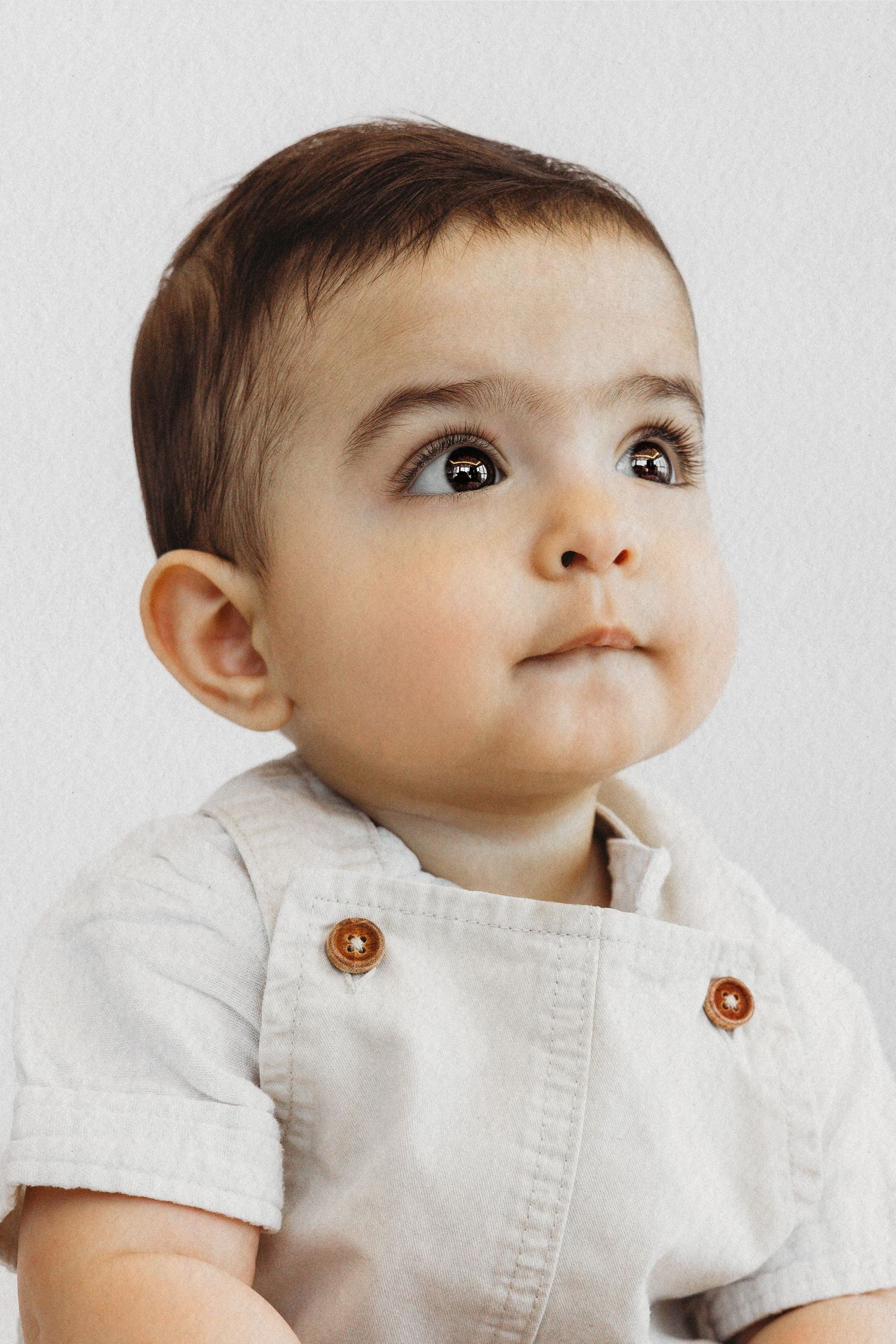Baby boy in a white outfit during a milestone session by Dounia Raphael Photography in Lebanon