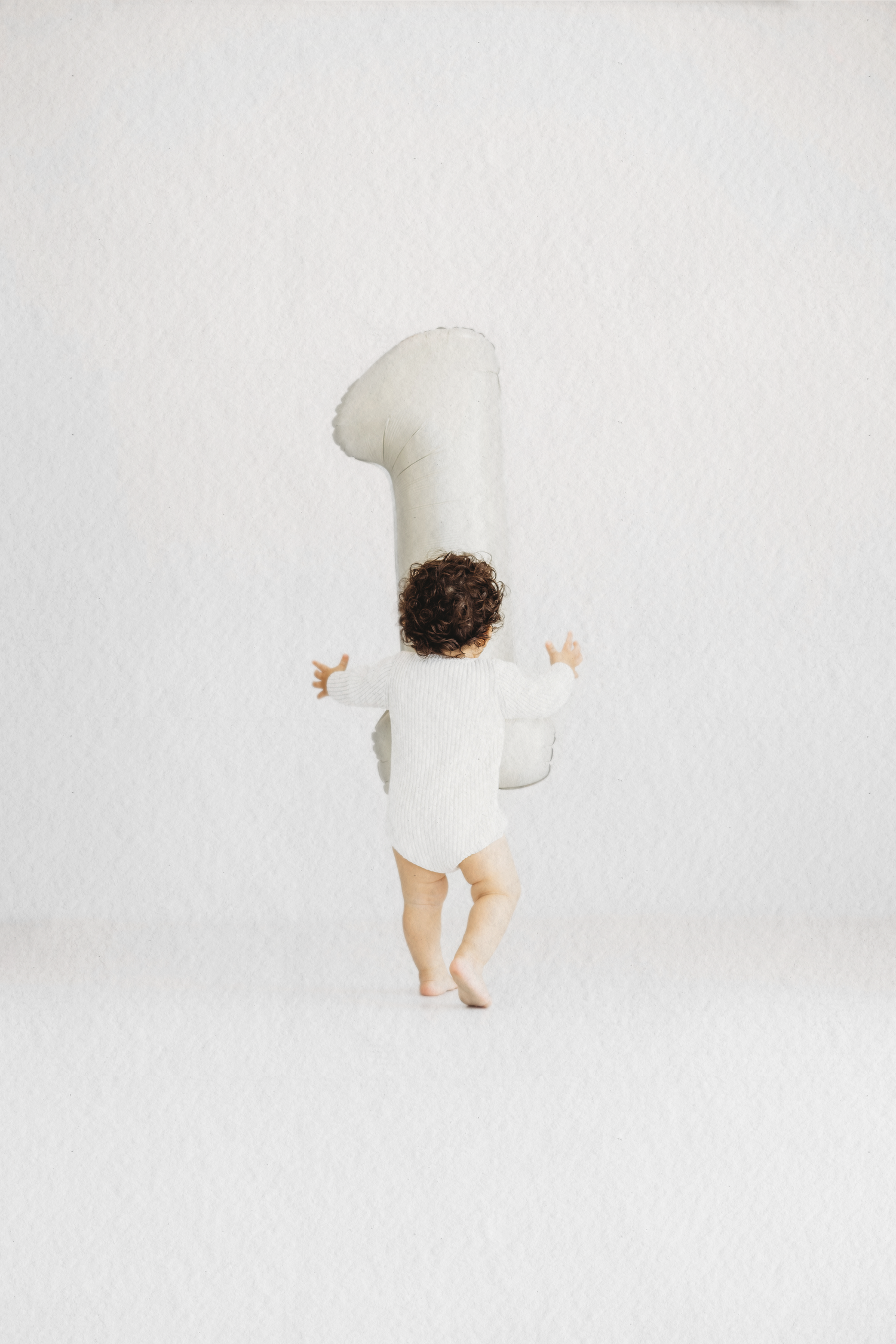 Baby with a number one balloon at their first birthday session in Dbayeh, Lebanon