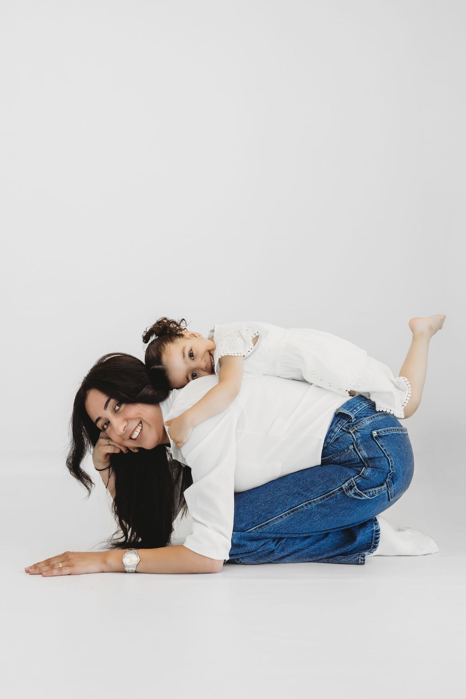 Tender mother and child moment captured in a white studio in Lebanon