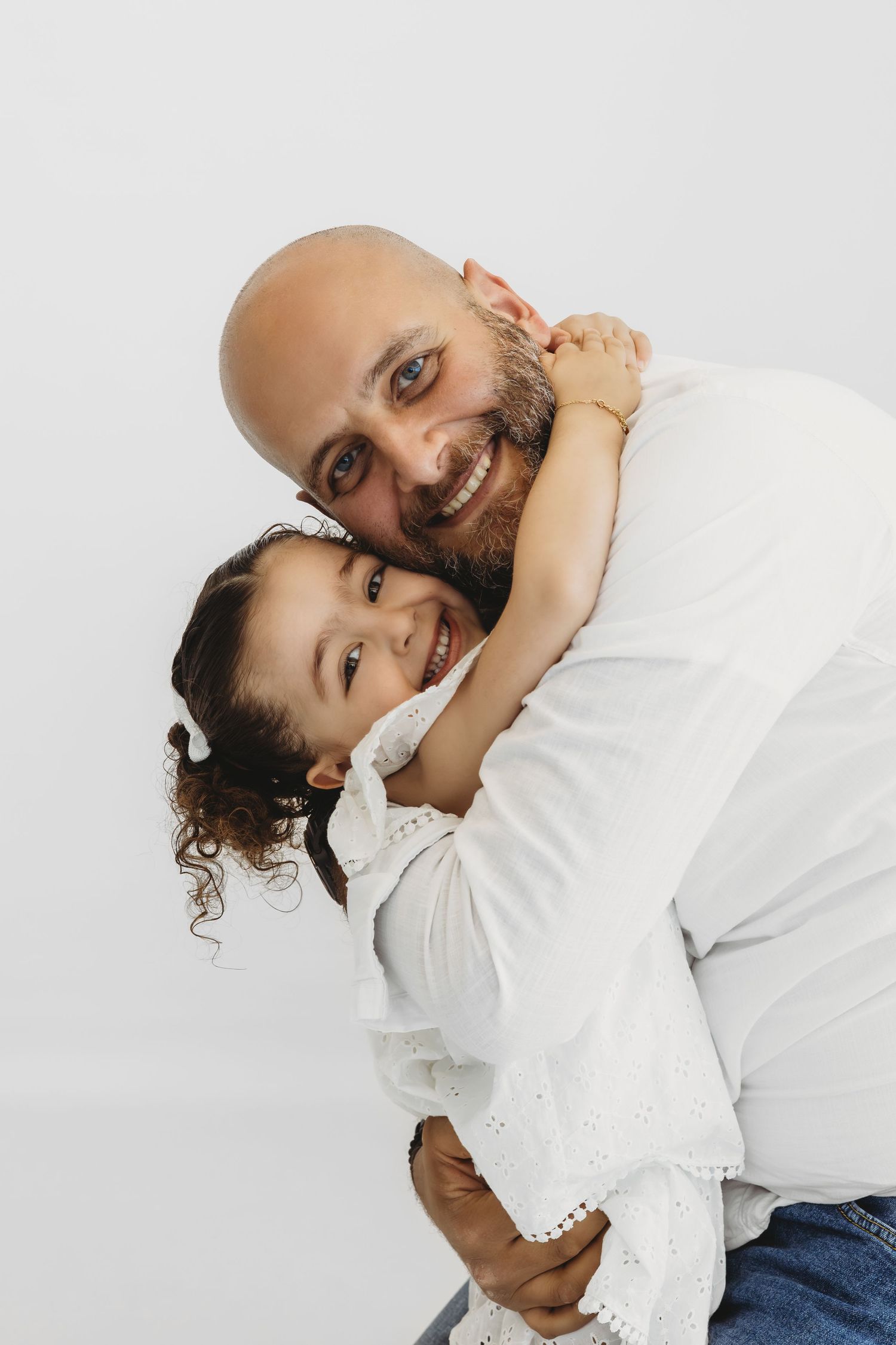 Joyful family portrait with parents and child by Dounia Raphael Photography in Lebanon