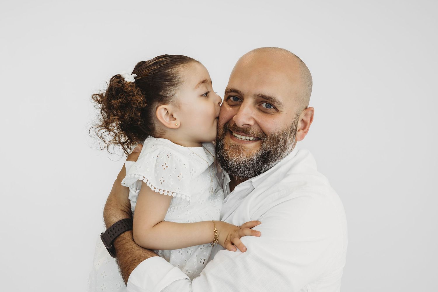 Father and daughter sharing a tender moment during a family photoshoot in Dbayeh, Lebanon