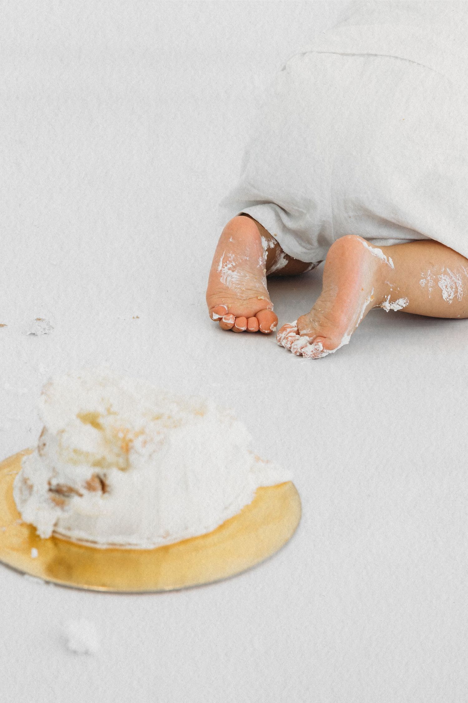 Baby's hands in the cake during a first birthday cake smash session in Dbayeh, Lebanon