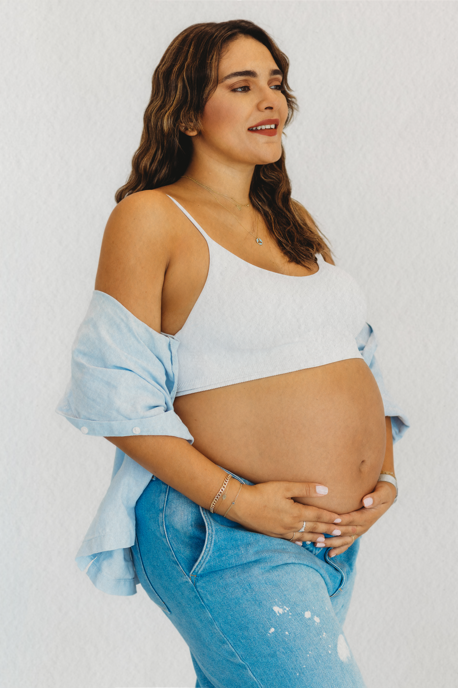 Natural maternity portrait in jeans and white top by Dounia Raphael Photography in Lebanon