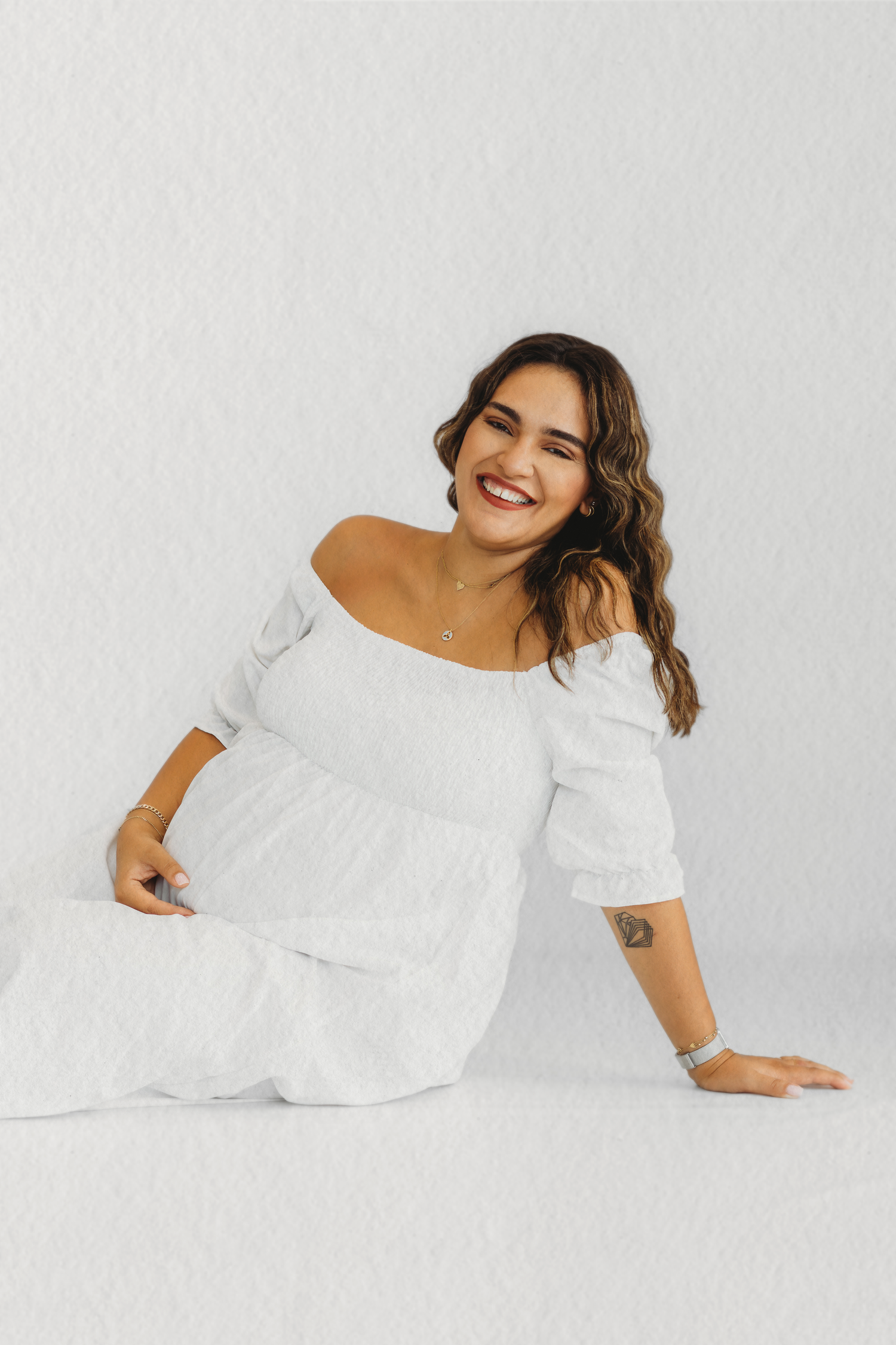 Expecting mother cradling her bump during a maternity photoshoot in Dbayeh, Lebanon