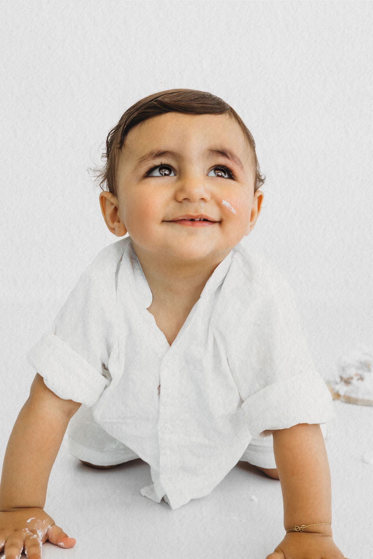 Smiling baby boy during a studio milestone session by Dounia Raphael Photography