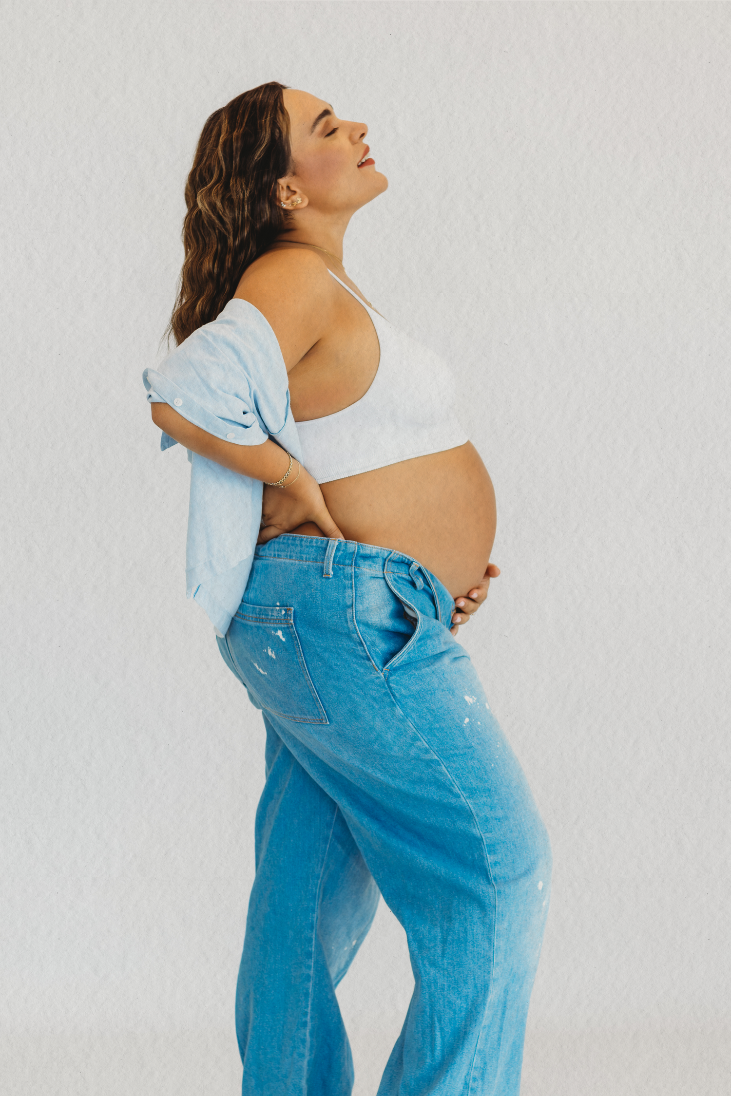 Pregnant mother in white top and jeans during a maternity session in Dbayeh, Lebanon