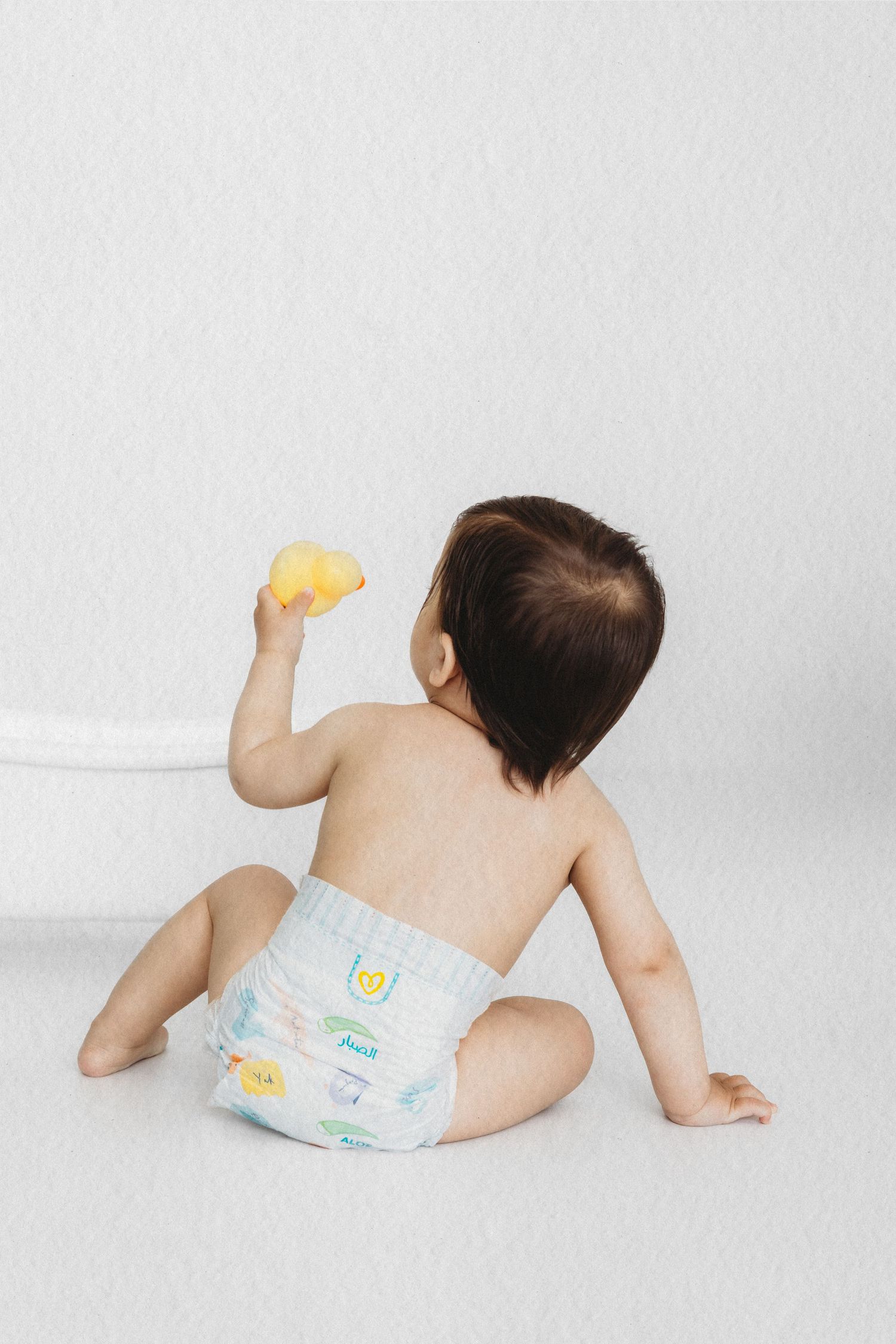 Baby enjoying a bubble bath photoshoot in a white tub in Dbayeh, Lebanon