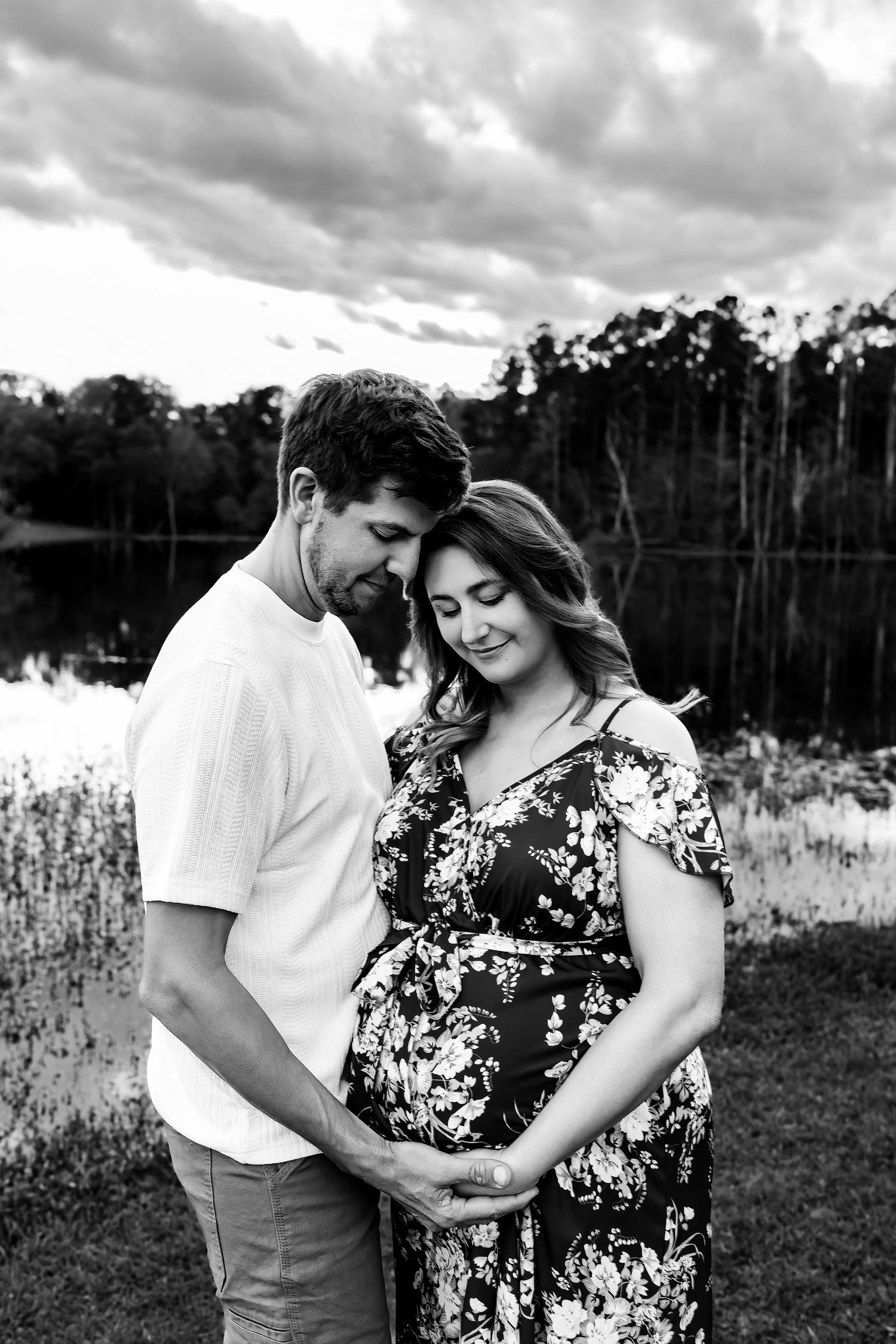 Black and White image of Mom and Dad to be embracing during a Lake Murray SC Maternity Session.