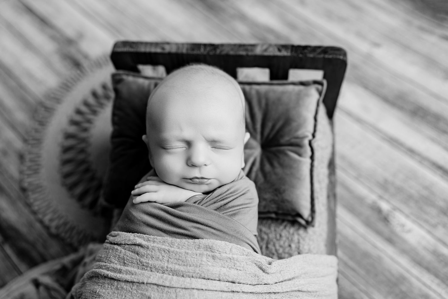Newborn boy posed on a tiny bed during a Chapin SC Studio Newborn Session.